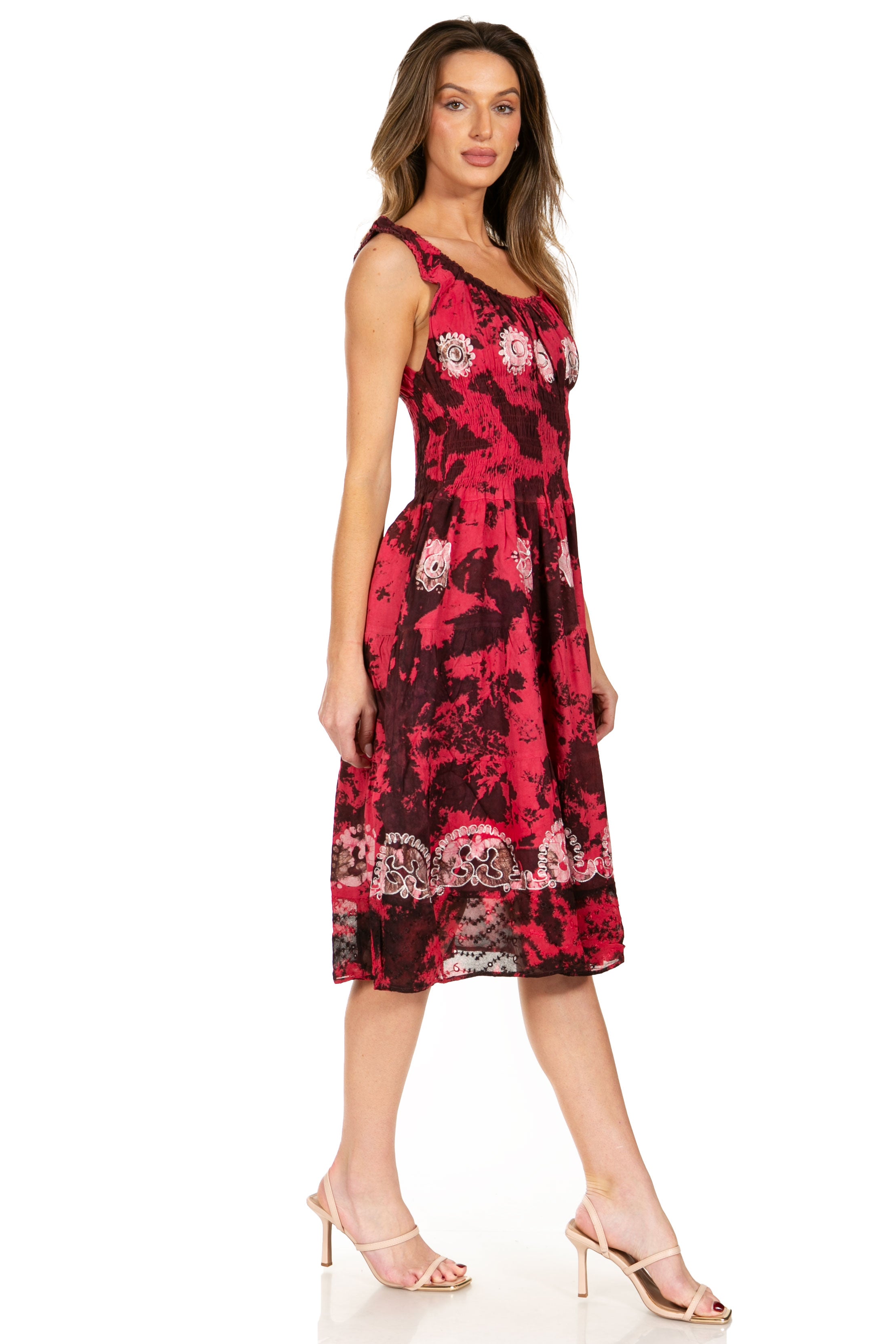 Woman wearing a red floral dress on a white background