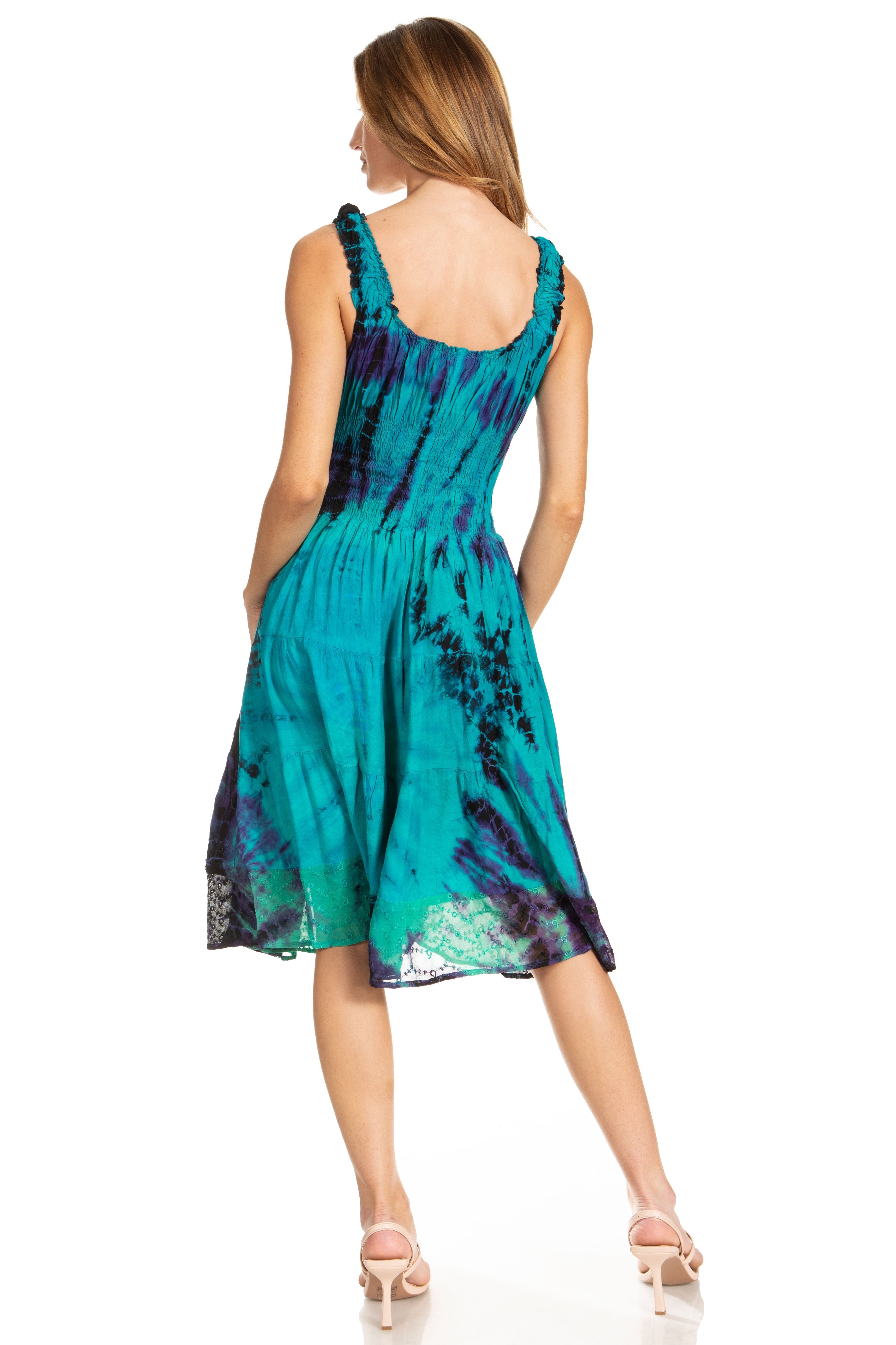 Woman wearing a teal and purple tie-dye dress on a white background