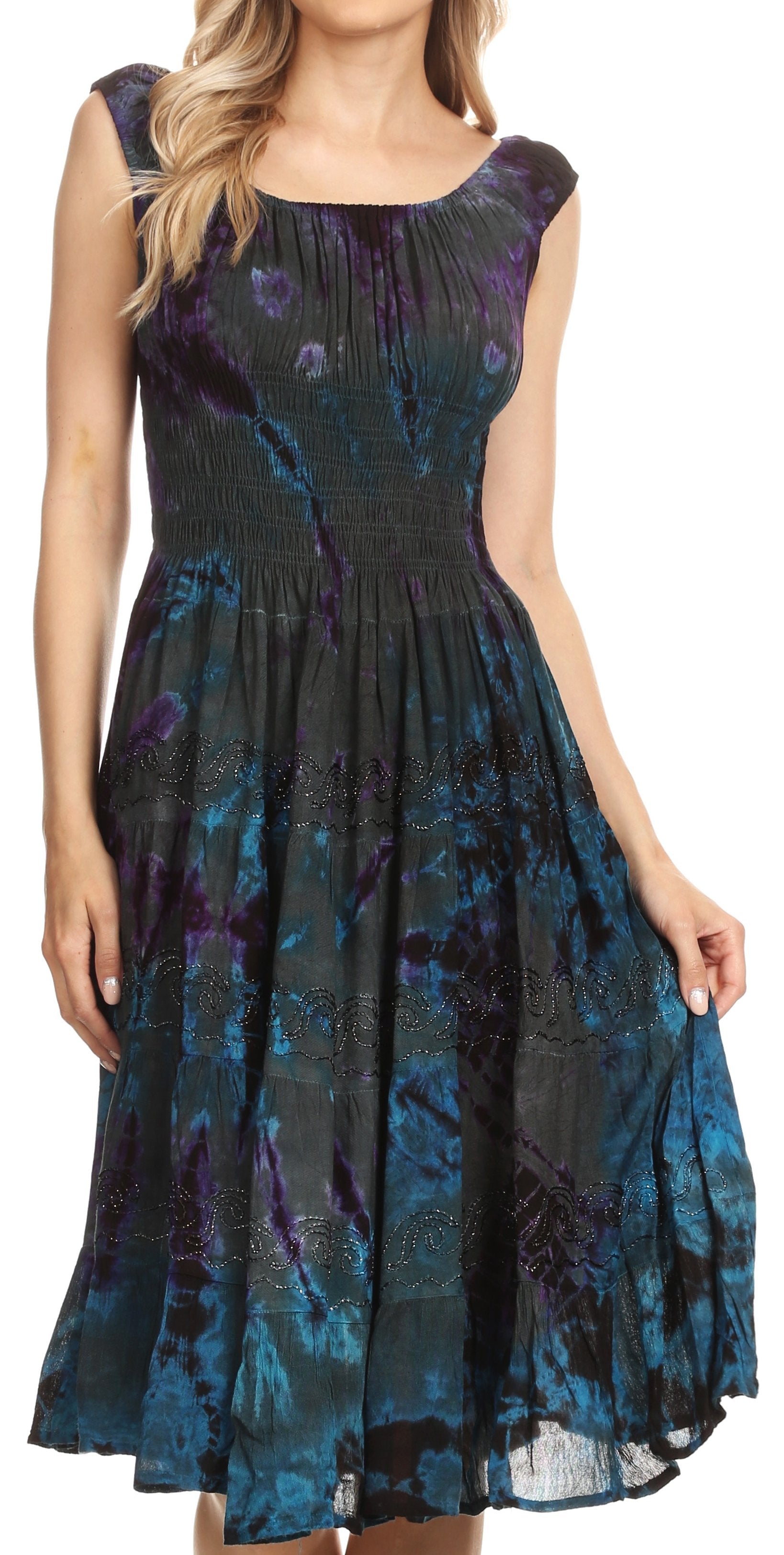 Woman wearing a sleeveless dress with a blue and purple floral pattern on a white background