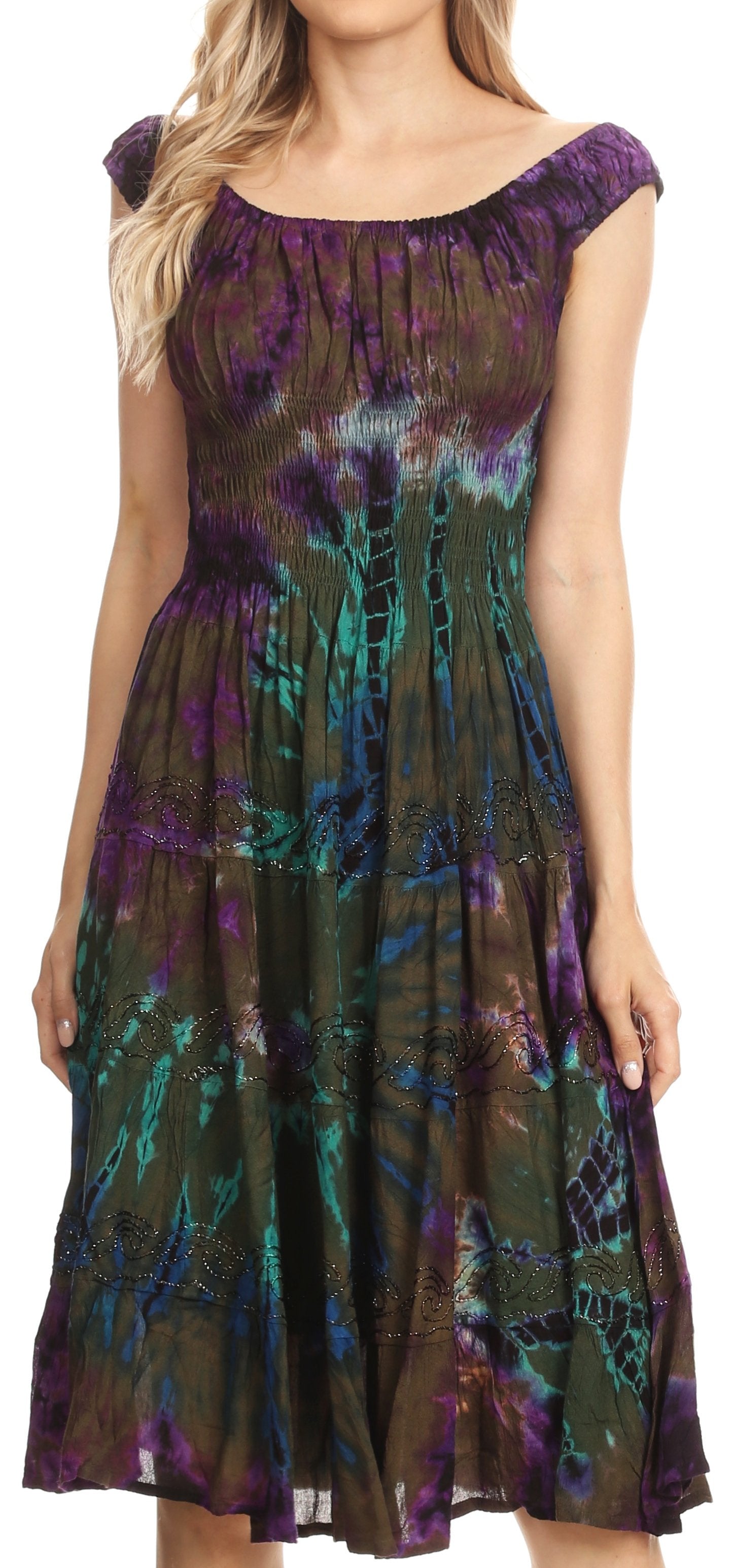 Woman wearing a tie-dye dress with purple and green patterns on a white background
