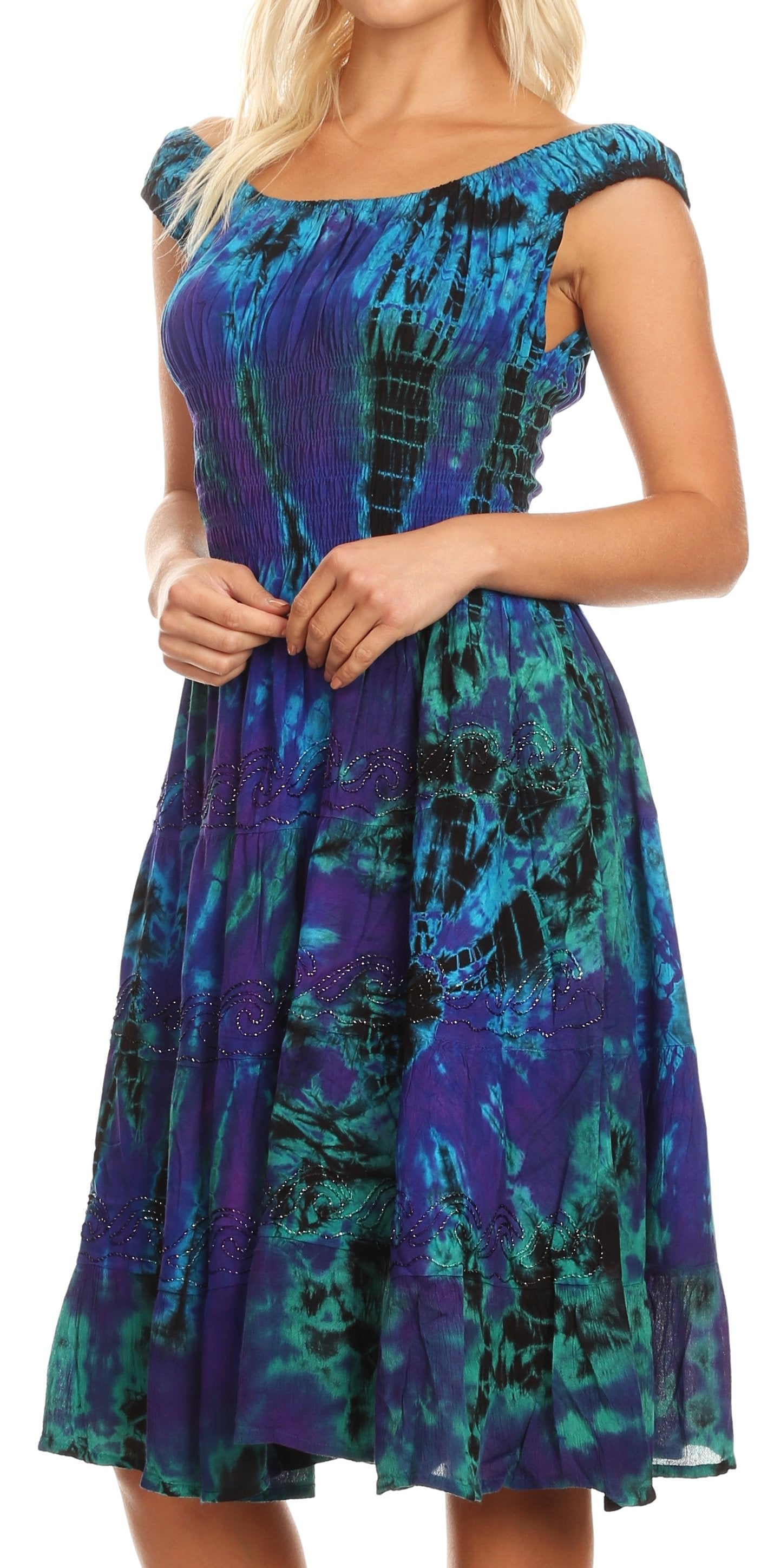 Woman wearing a blue and green patterned dress on a white background