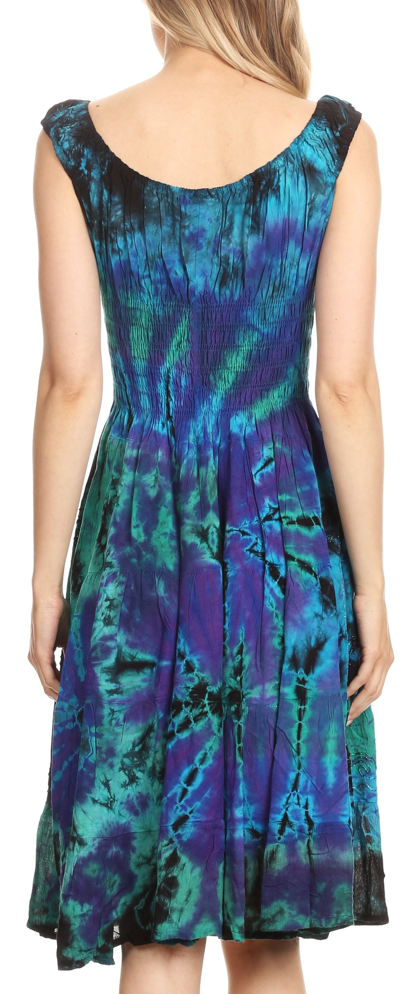 Woman wearing a sleeveless dress with a blue and green abstract pattern.
