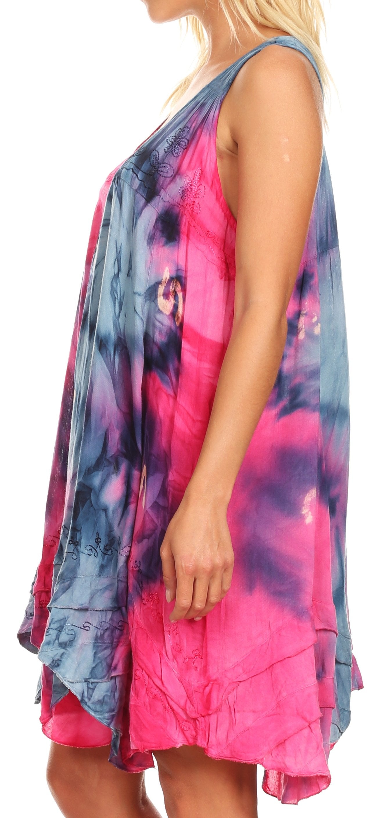 Woman wearing a colorful tie-dye dress with pink and blue hues on a white background