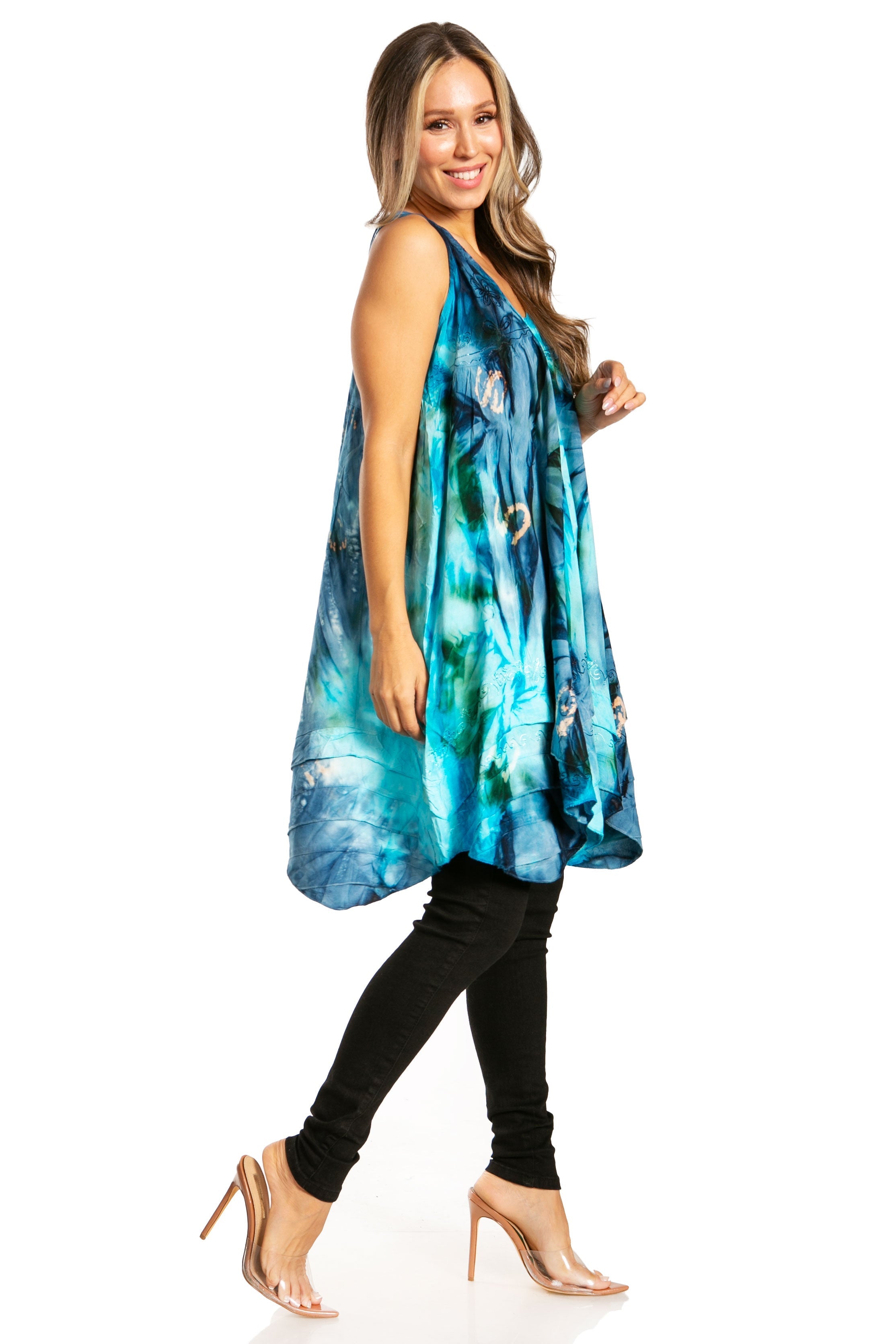Woman wearing a blue floral dress with black leggings on a white background