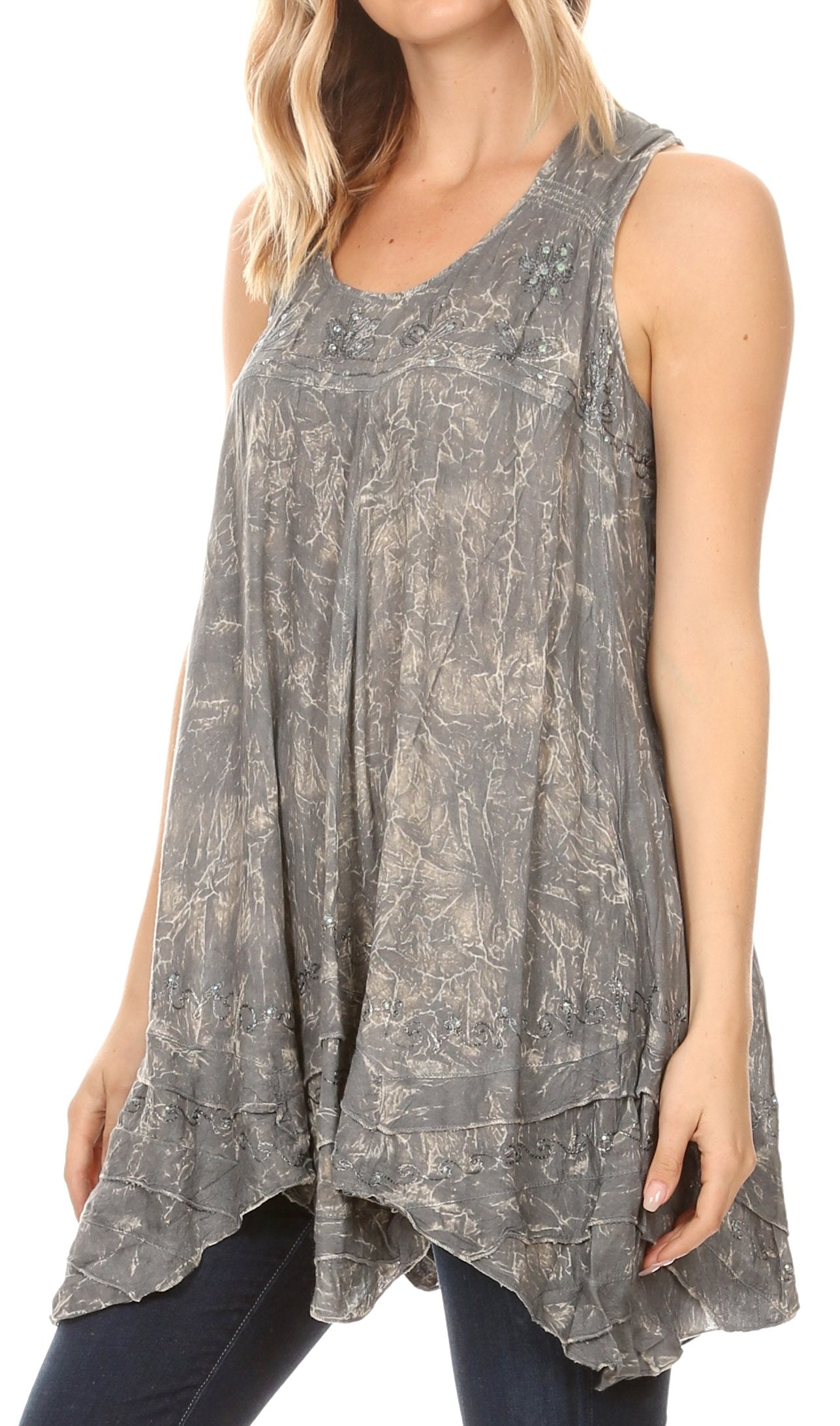 Woman wearing a sleeveless, patterned top with a white background