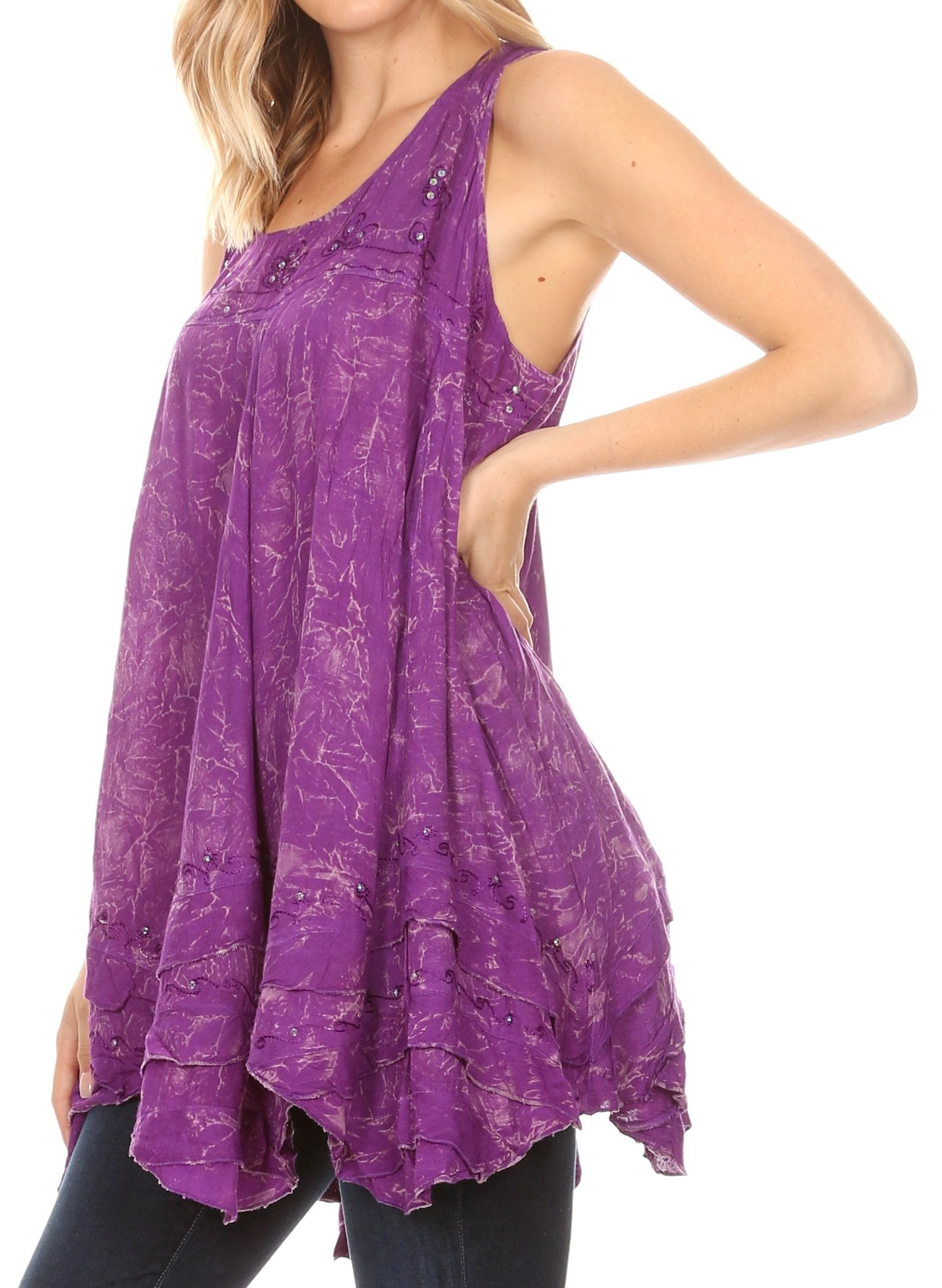 Woman wearing a purple sleeveless top with a floral pattern on a white background