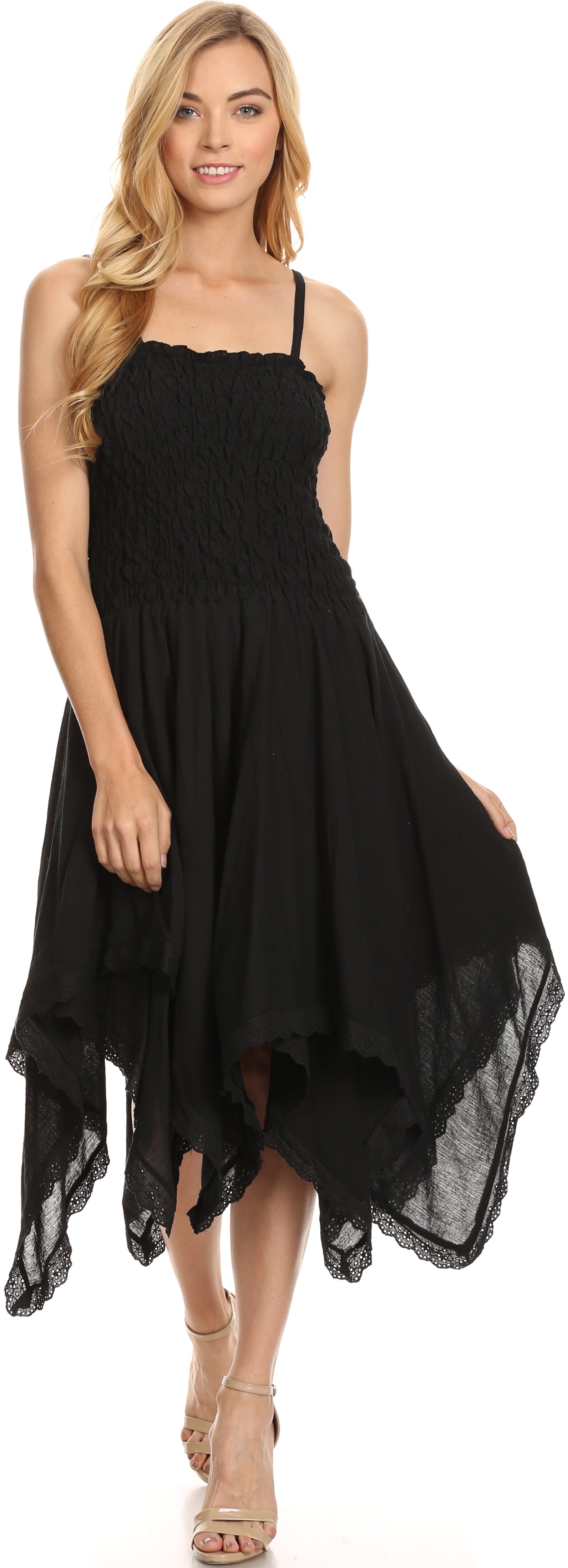 Woman wearing a black dress with an asymmetrical hem on a white background