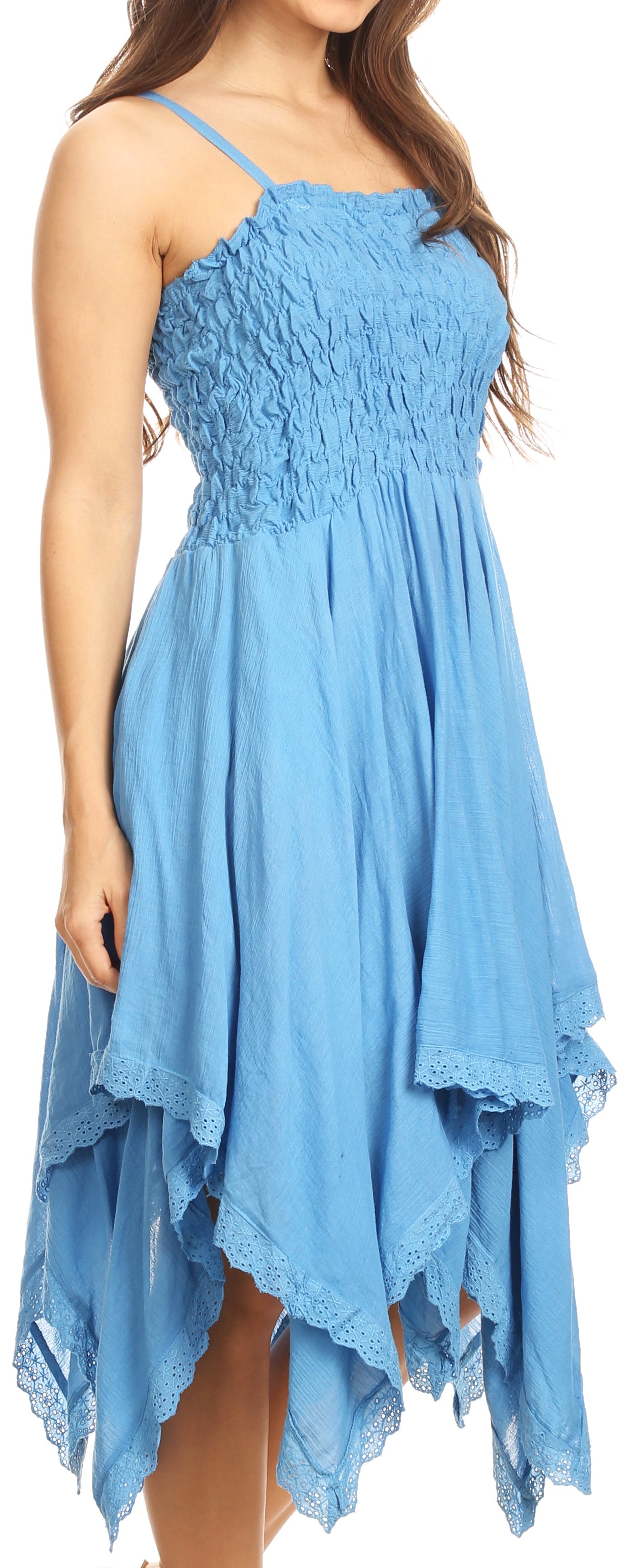 Woman wearing a blue dress with a smocked bodice and flowing skirt.