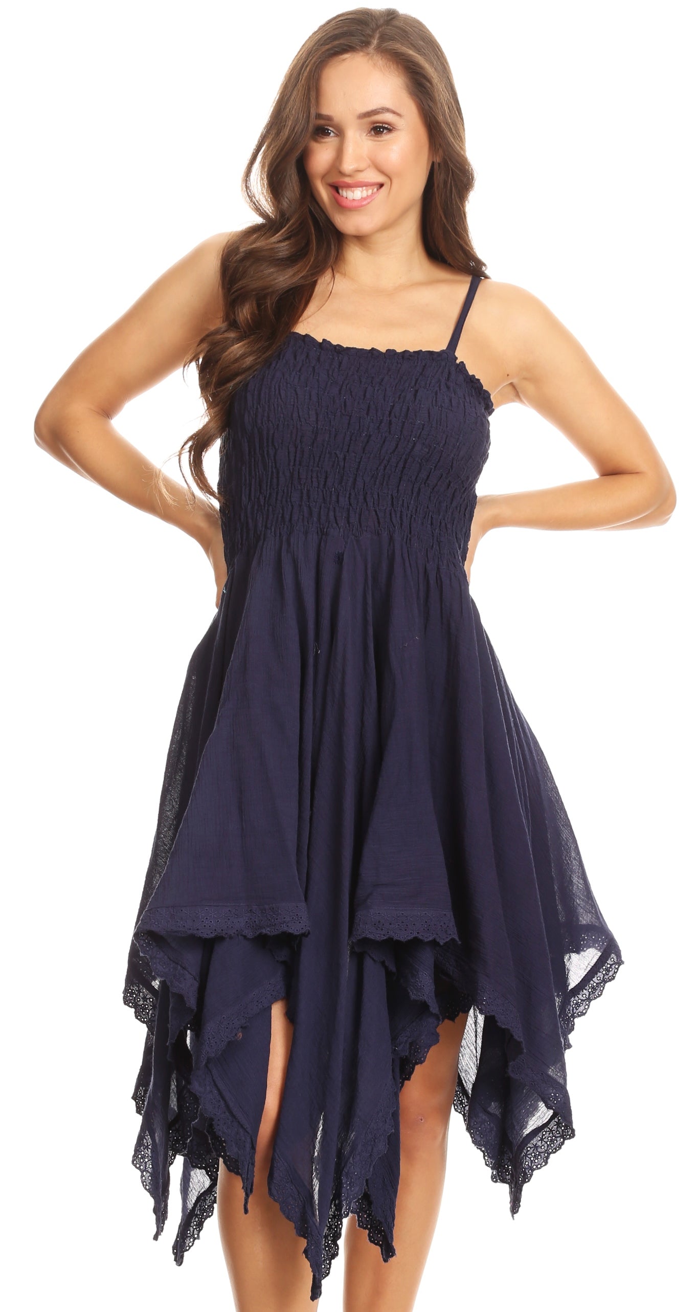 Woman wearing a navy blue dress with lace details on a white background