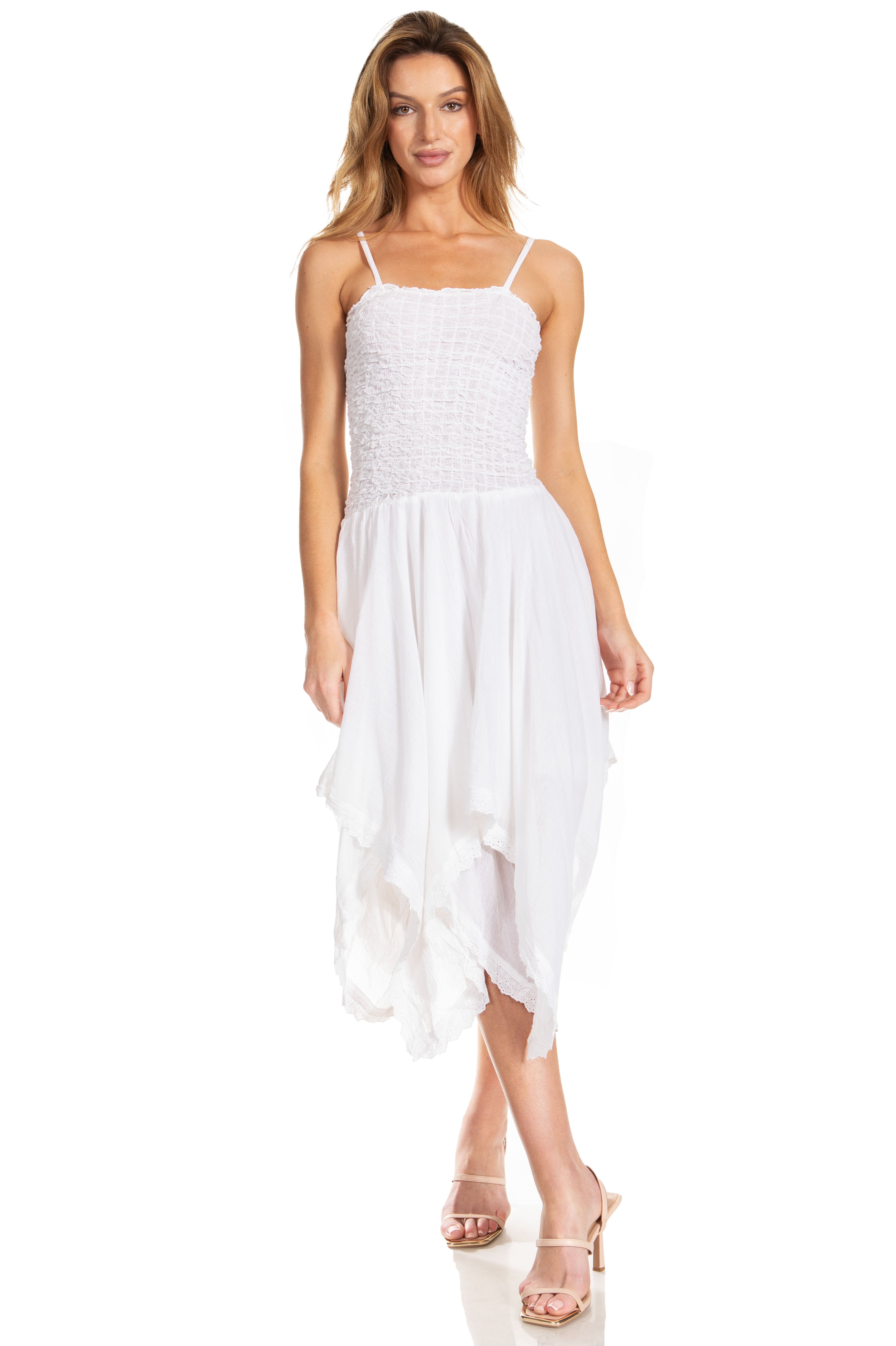 Woman wearing a white dress with a plain background