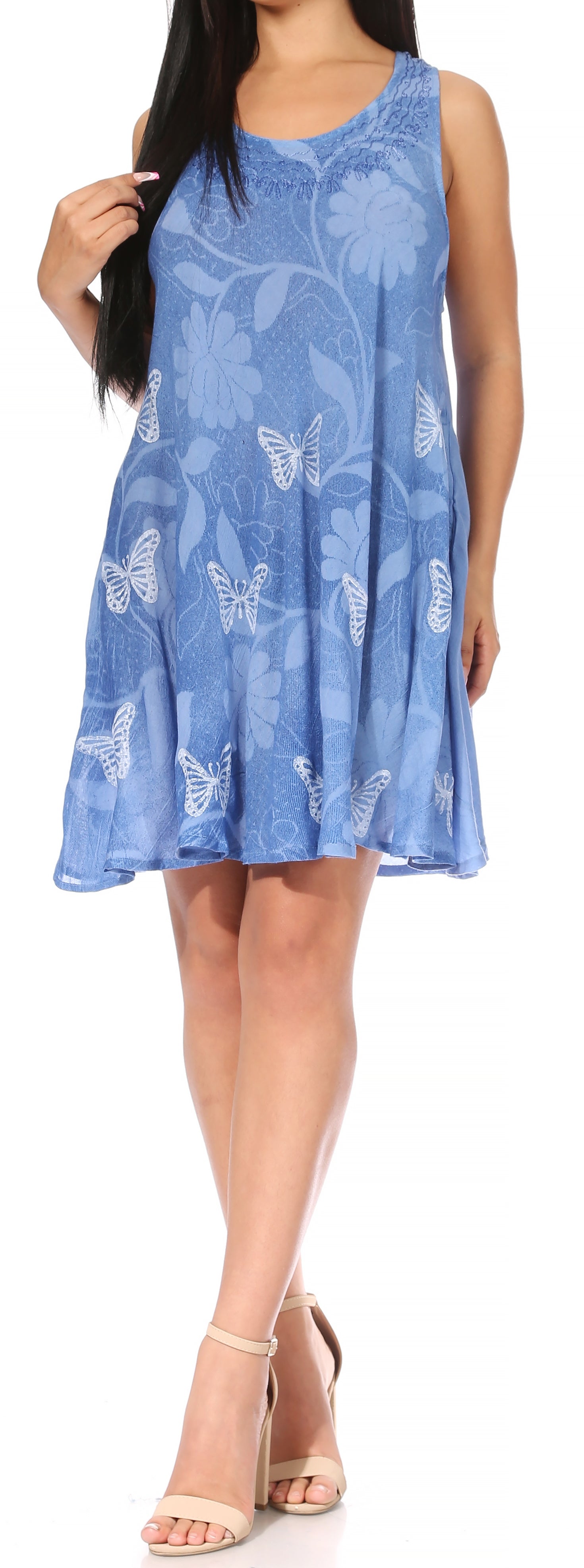 Woman wearing a blue dress with butterfly pattern on a white background