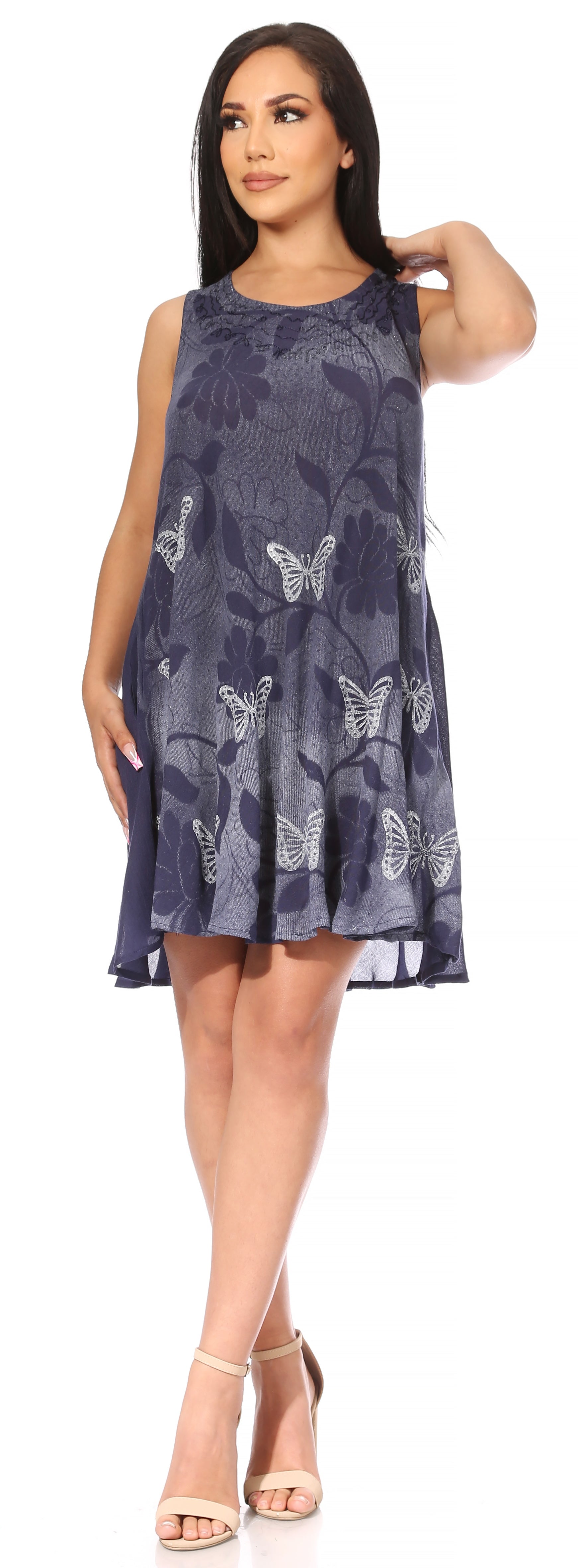 Woman wearing a sleeveless dress with butterfly pattern on a white background