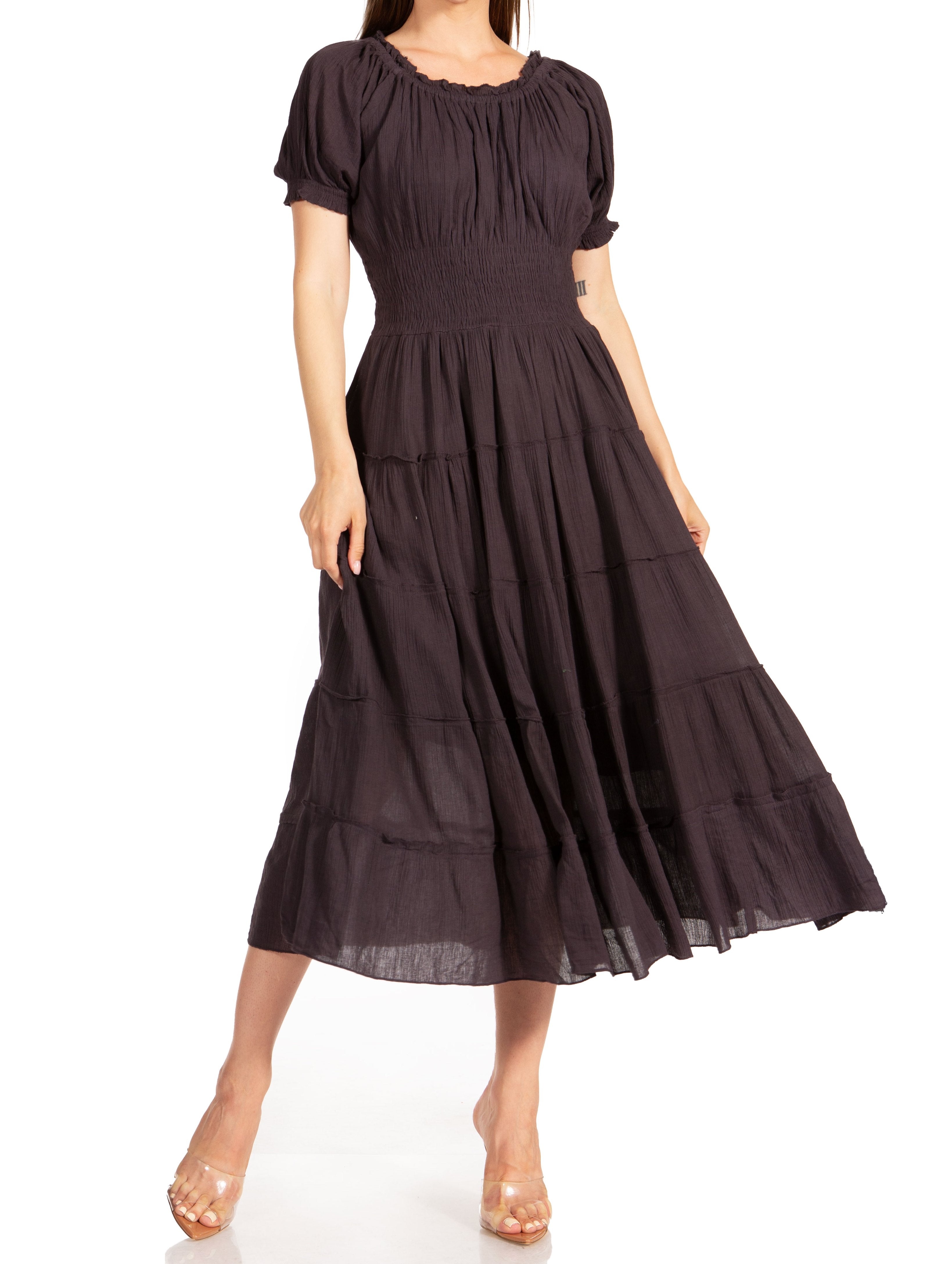 Woman wearing a dark brown dress with short sleeves and a tiered skirt on a white background