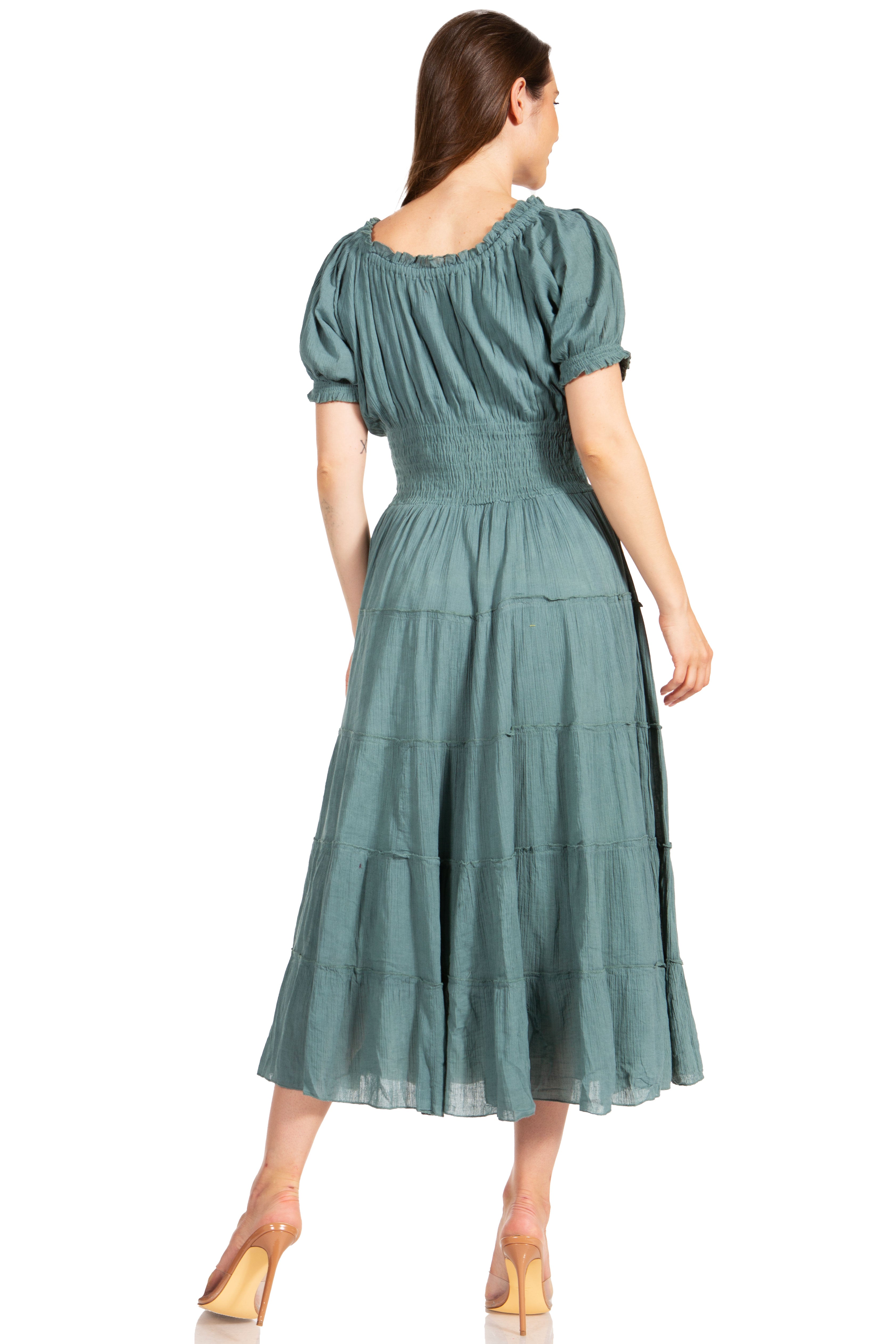 Woman wearing a green dress with puffed sleeves on a white background