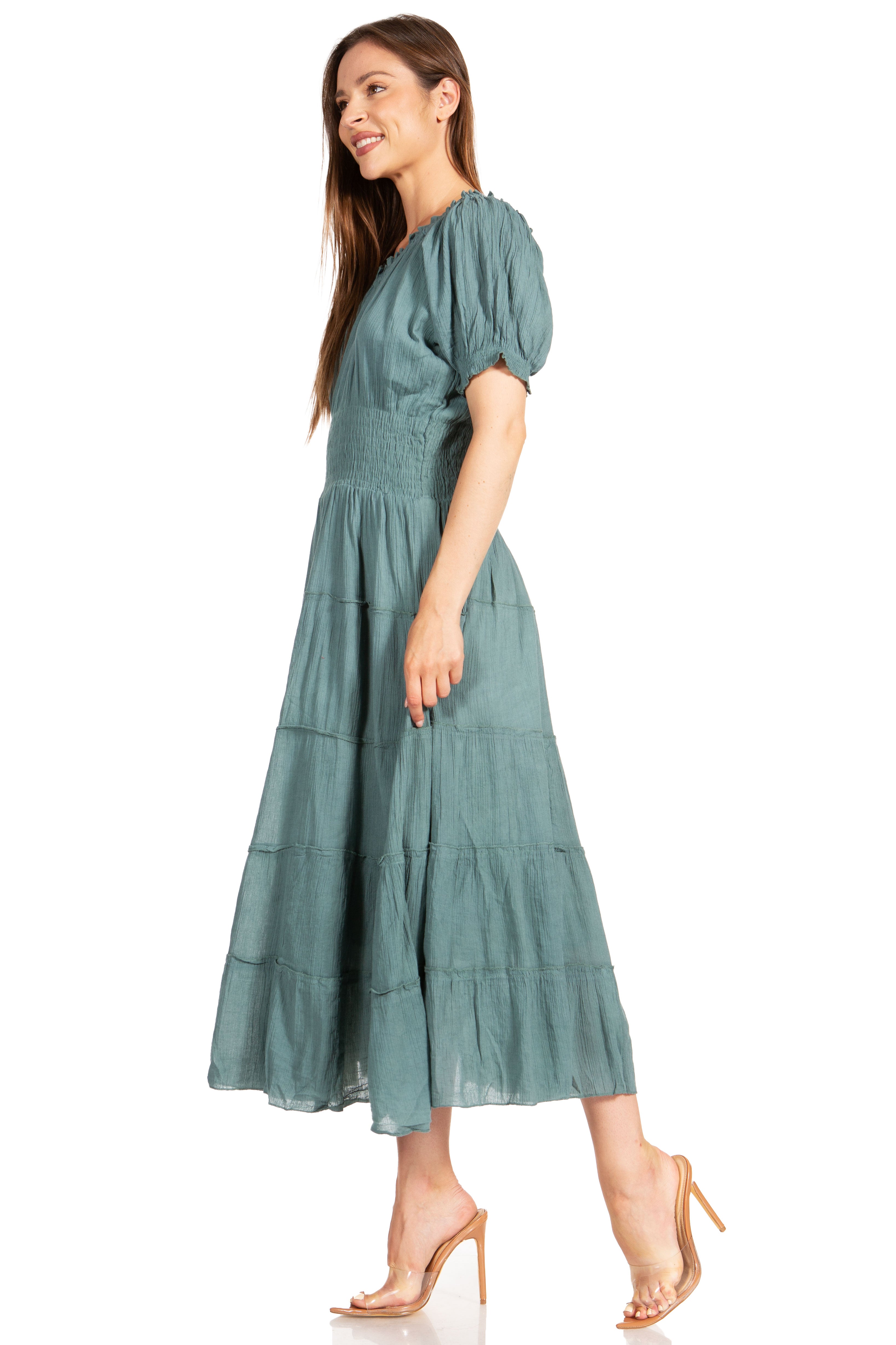 Woman wearing a teal dress on a white background