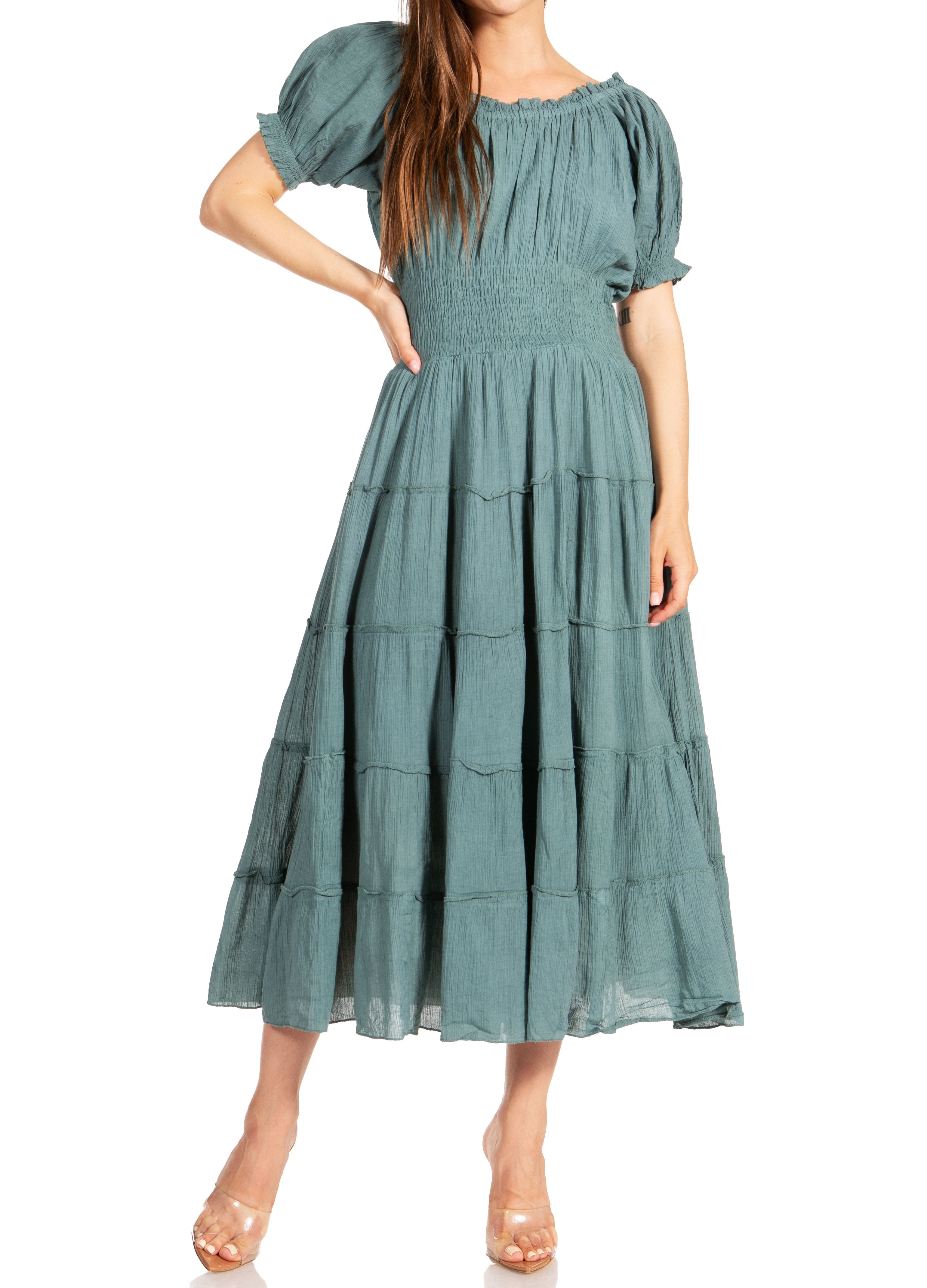 Woman wearing a green tiered dress on a white background