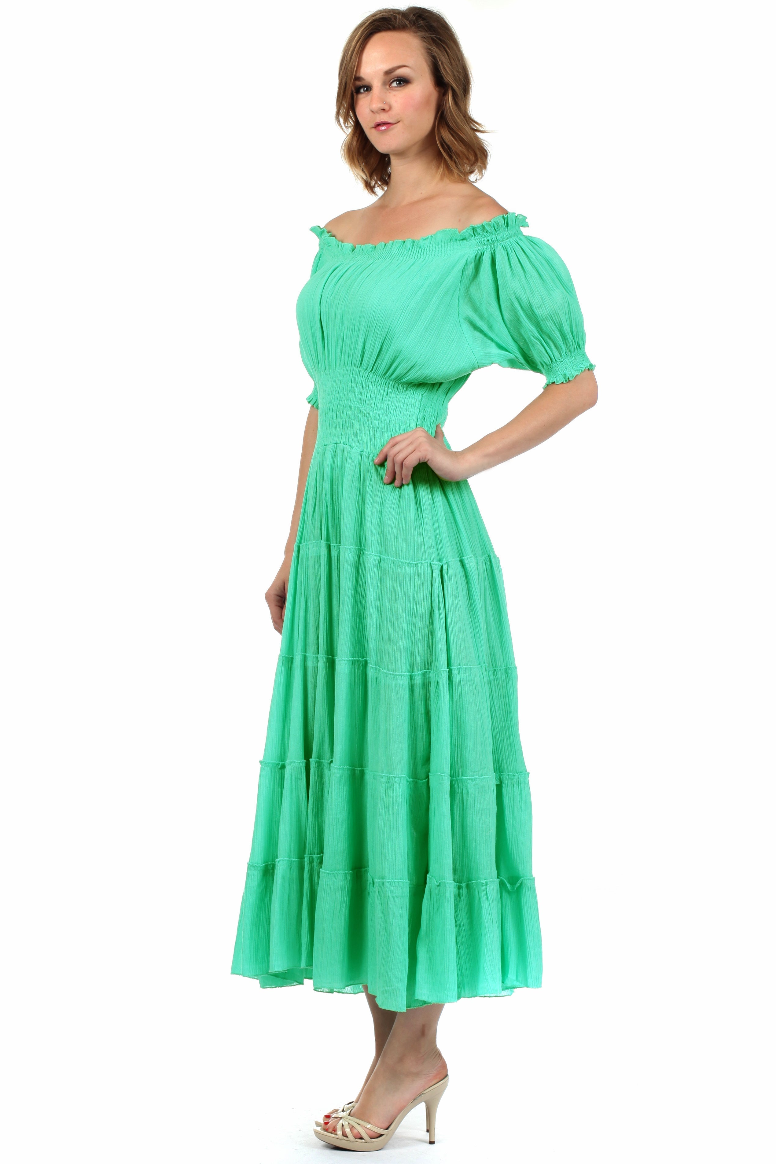 Woman wearing a green off-shoulder dress on a white background
