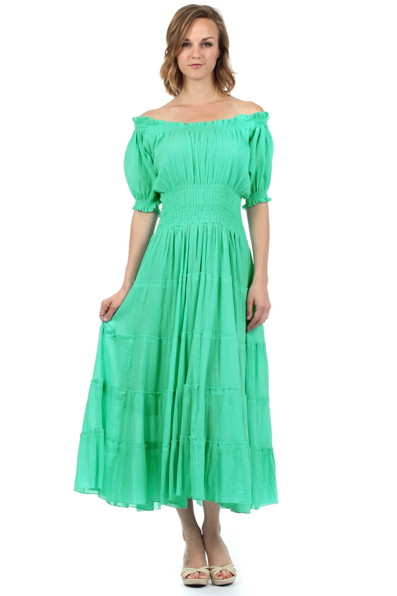 Woman wearing a green off-shoulder dress on a white background