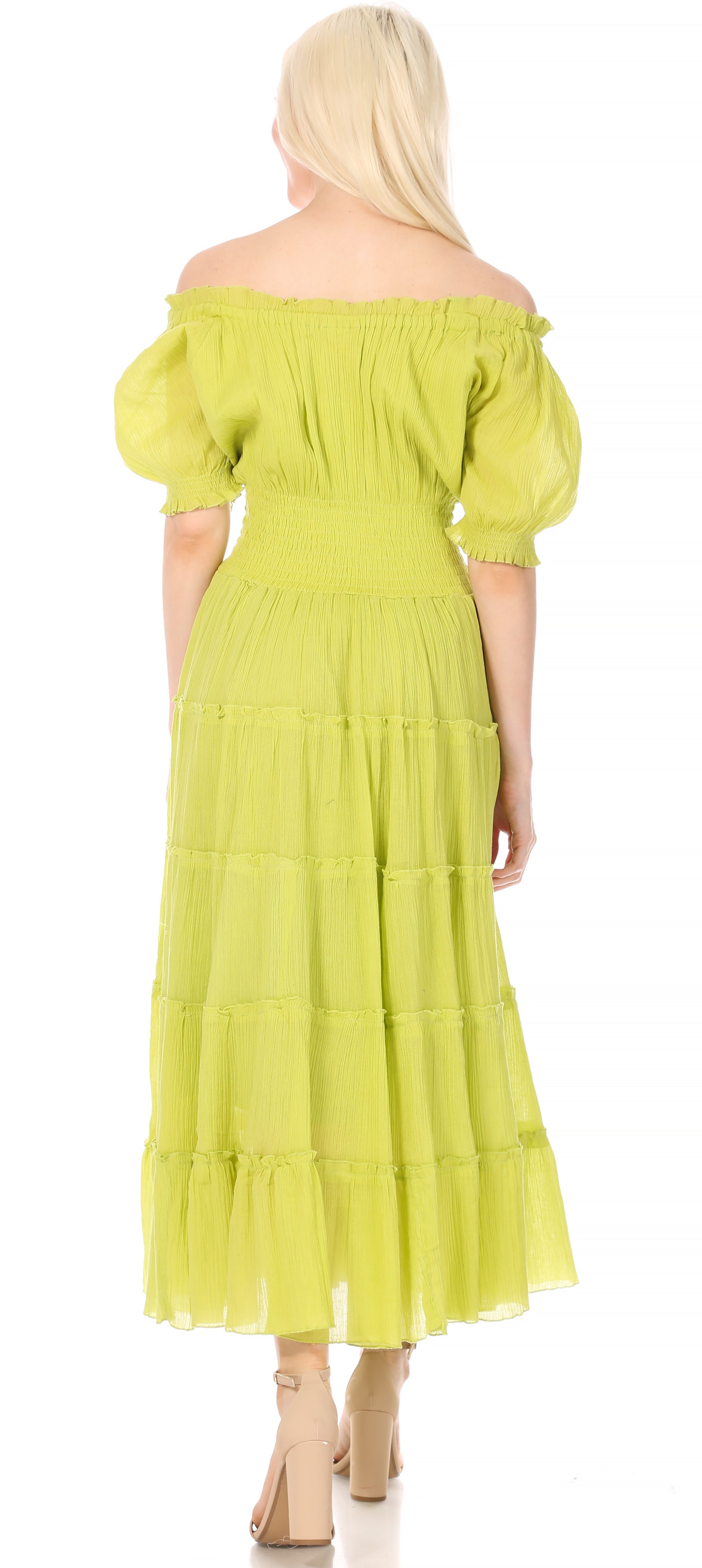 Woman wearing a light green off-shoulder dress with puff sleeves on a white background