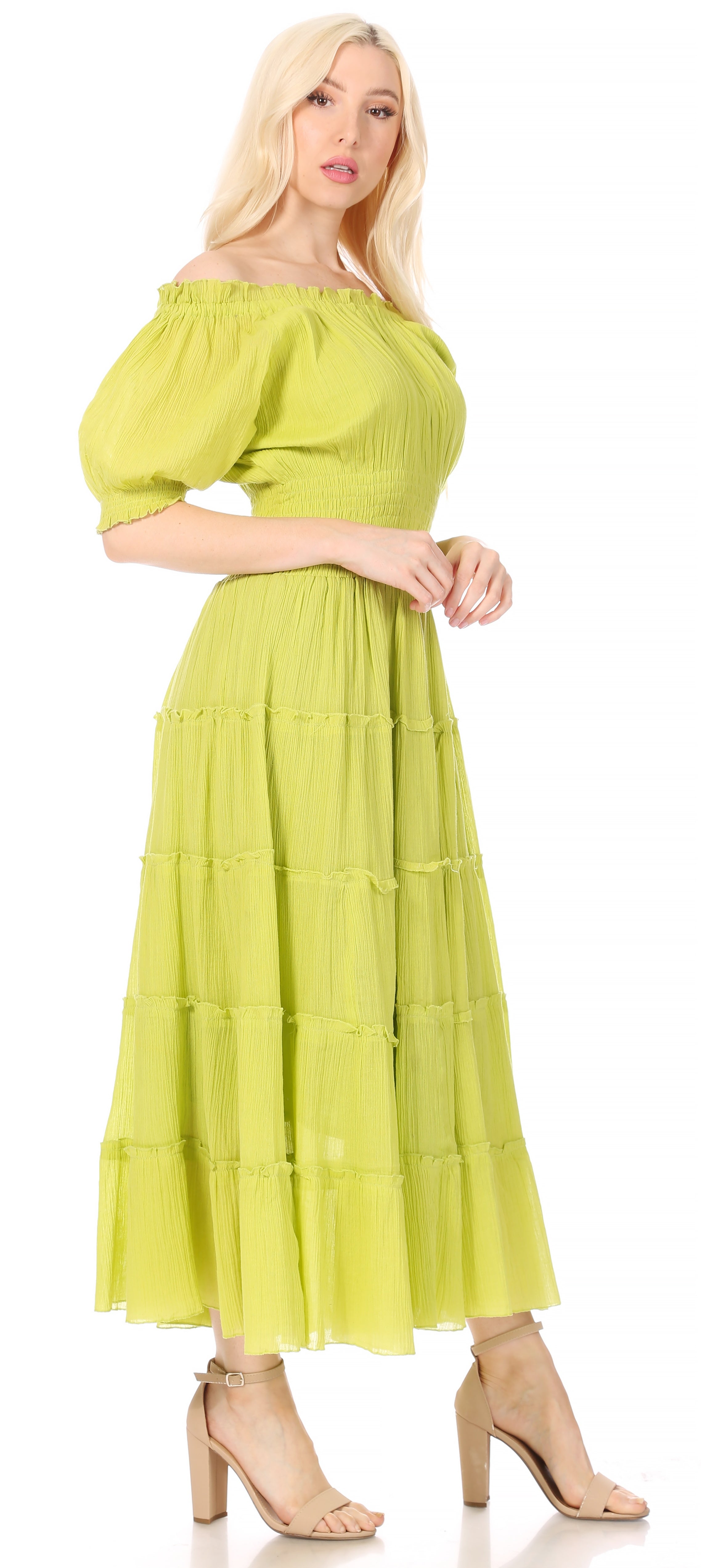 Woman wearing a light green off-shoulder dress with puffed sleeves on a white background