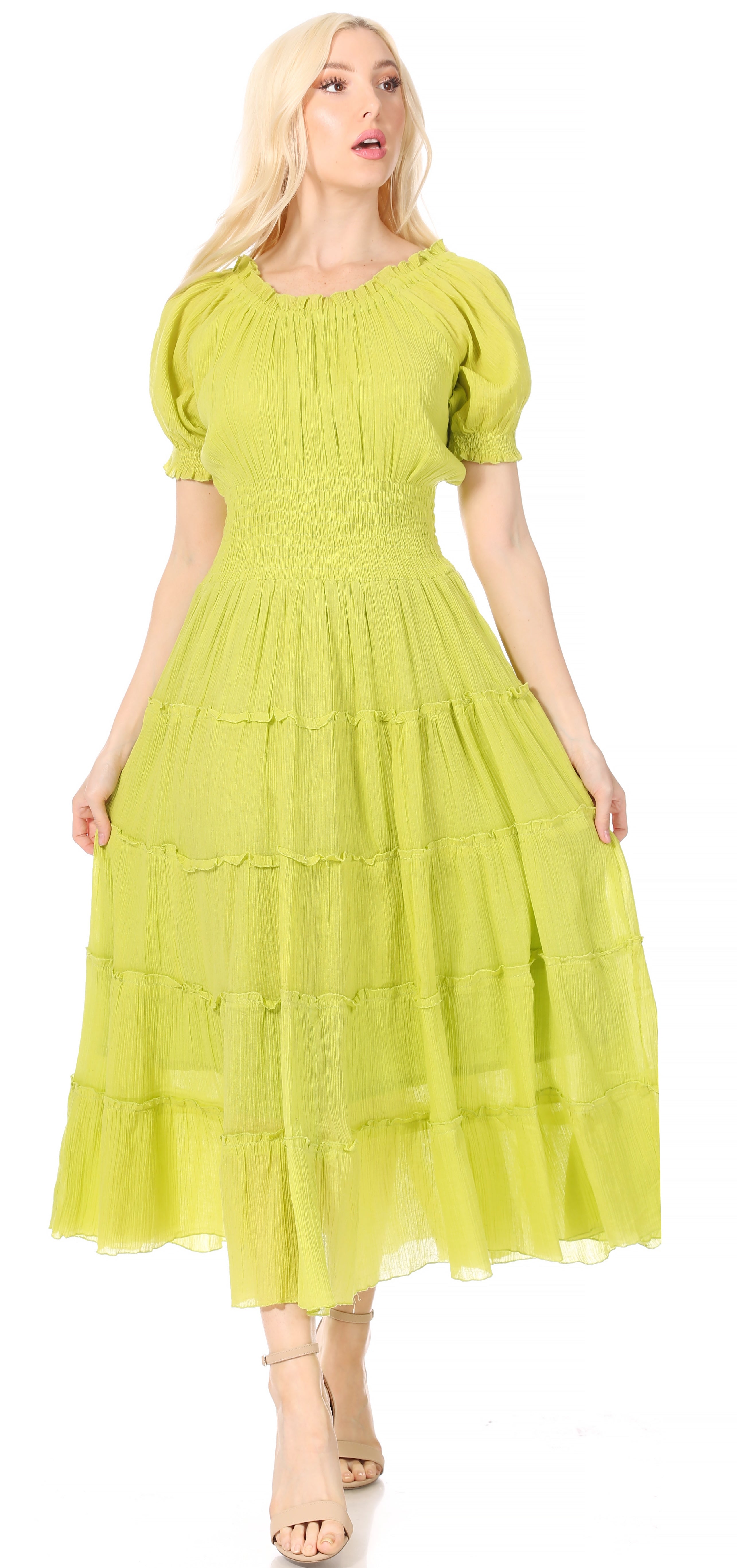 Woman wearing a bright green dress with puff sleeves on a white background