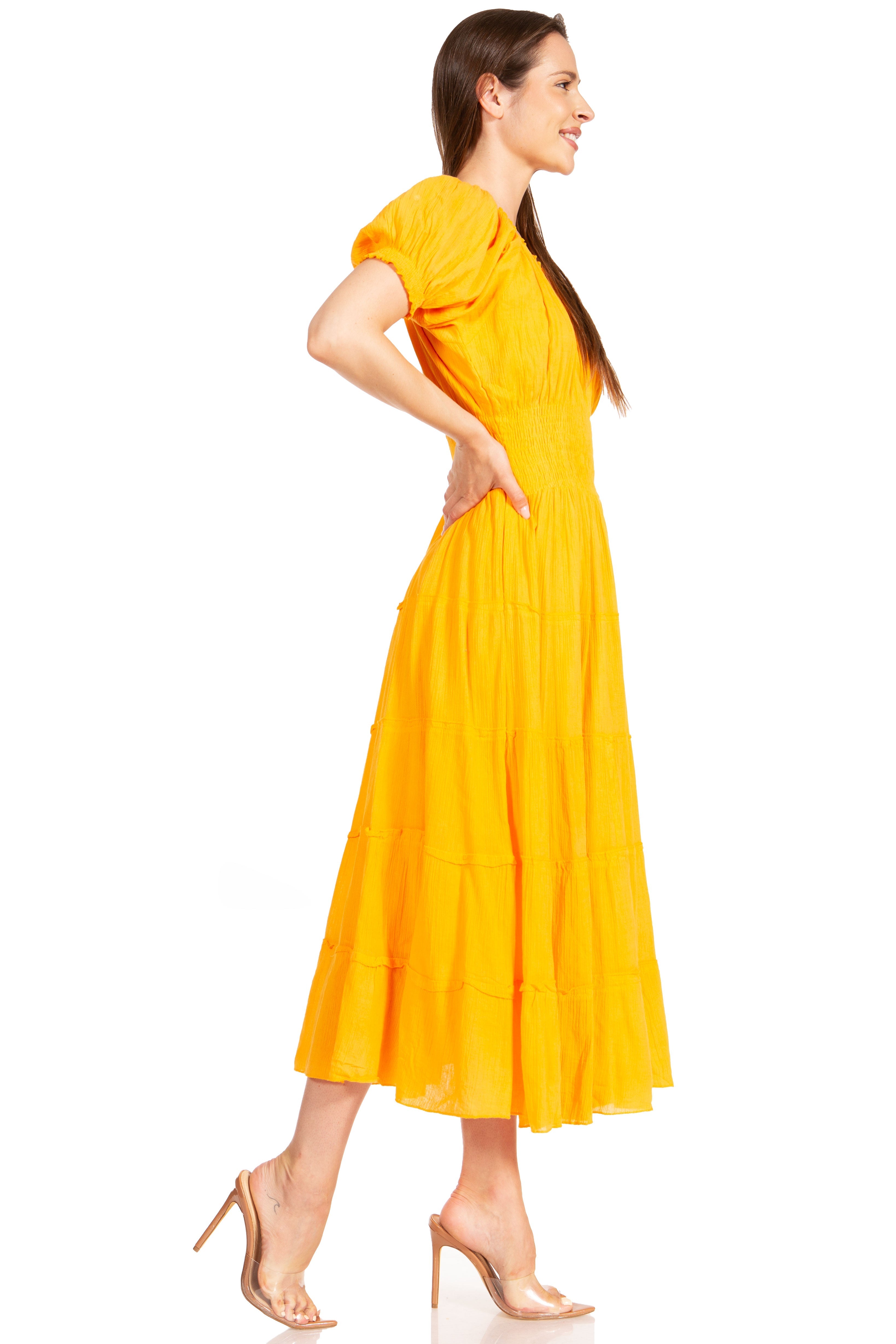 Woman wearing a yellow dress on a white background