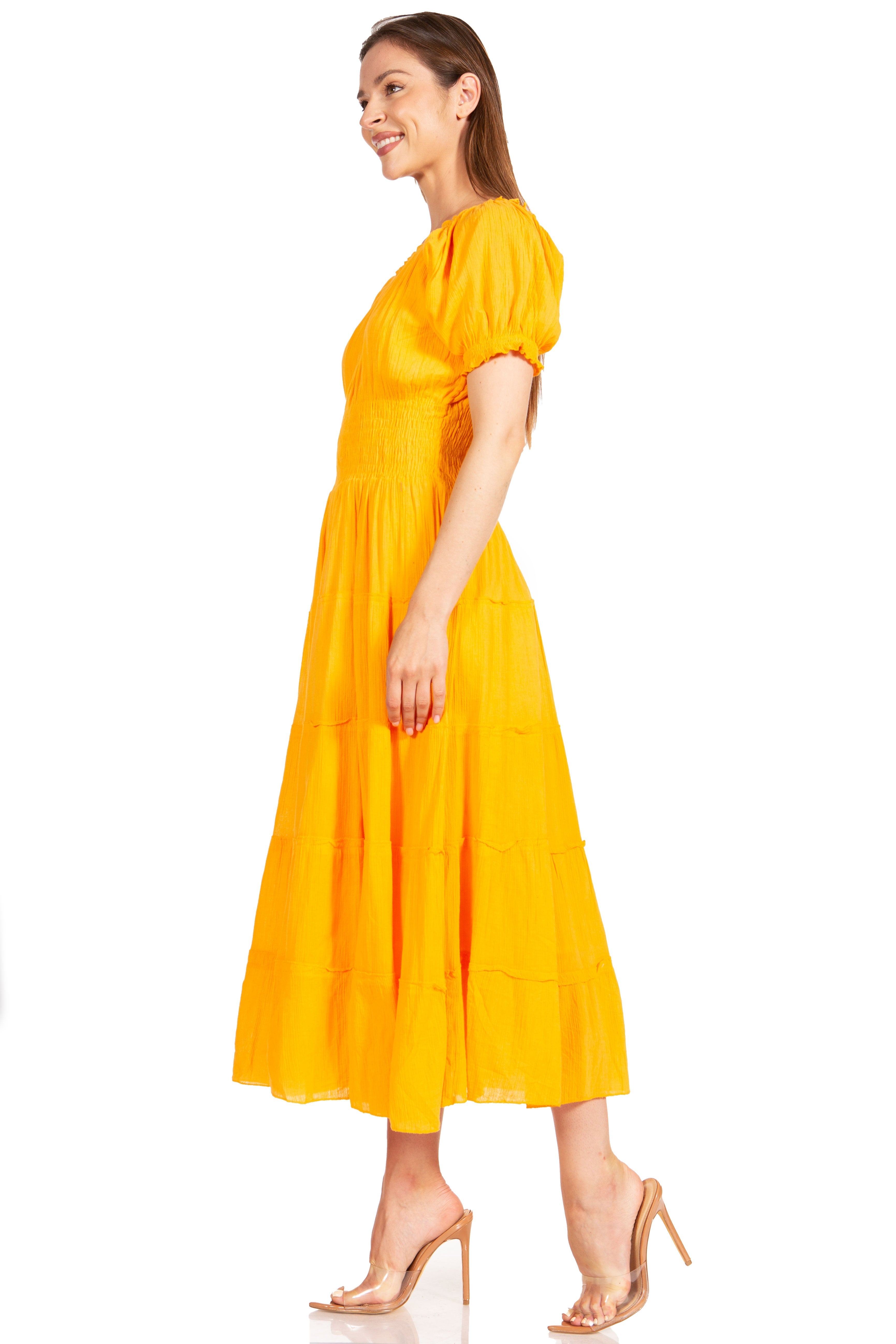 Woman wearing a yellow dress on a white background