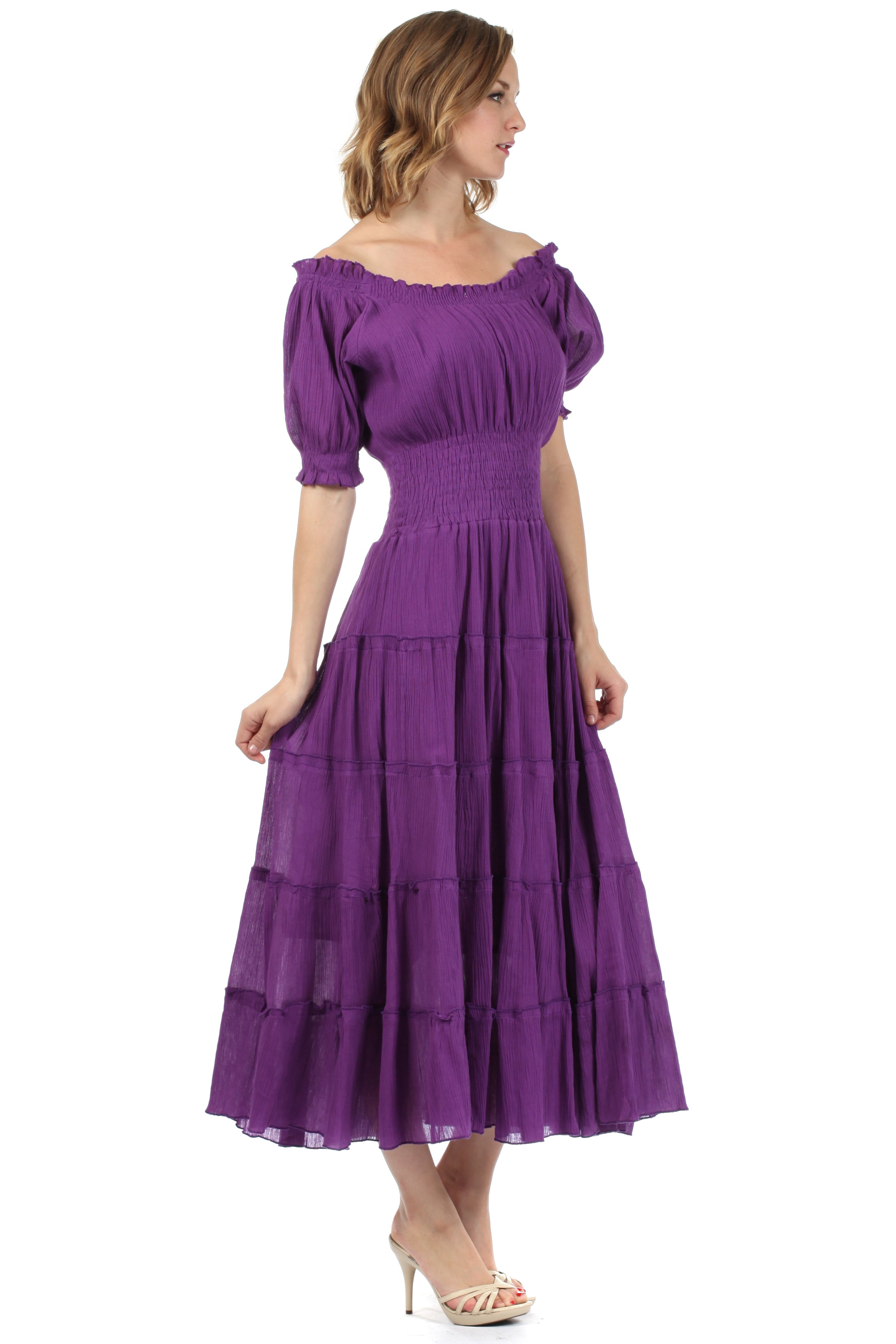 Woman wearing a purple dress with puffed sleeves on a white background
