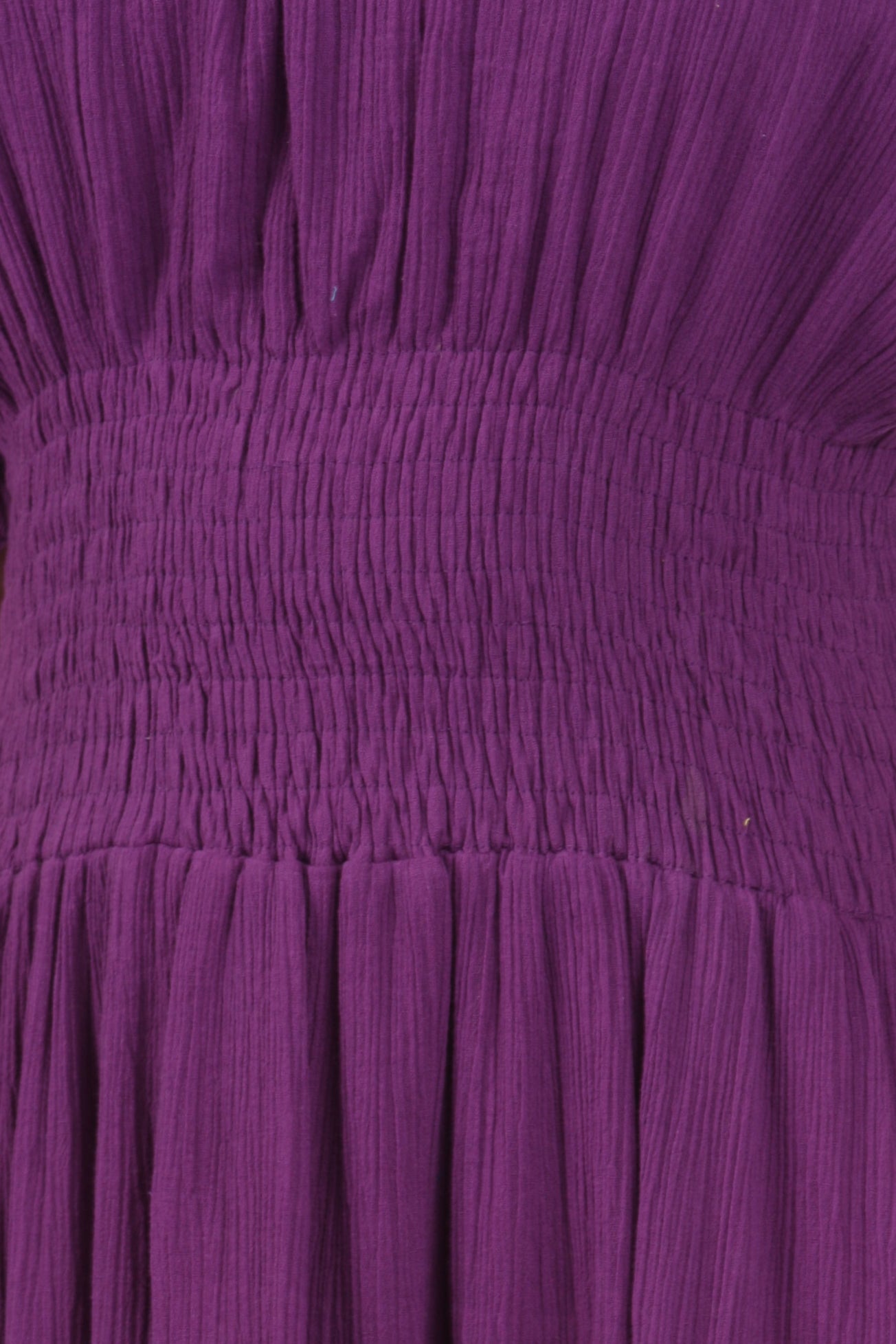 Close-up of a purple fabric with pleated texture