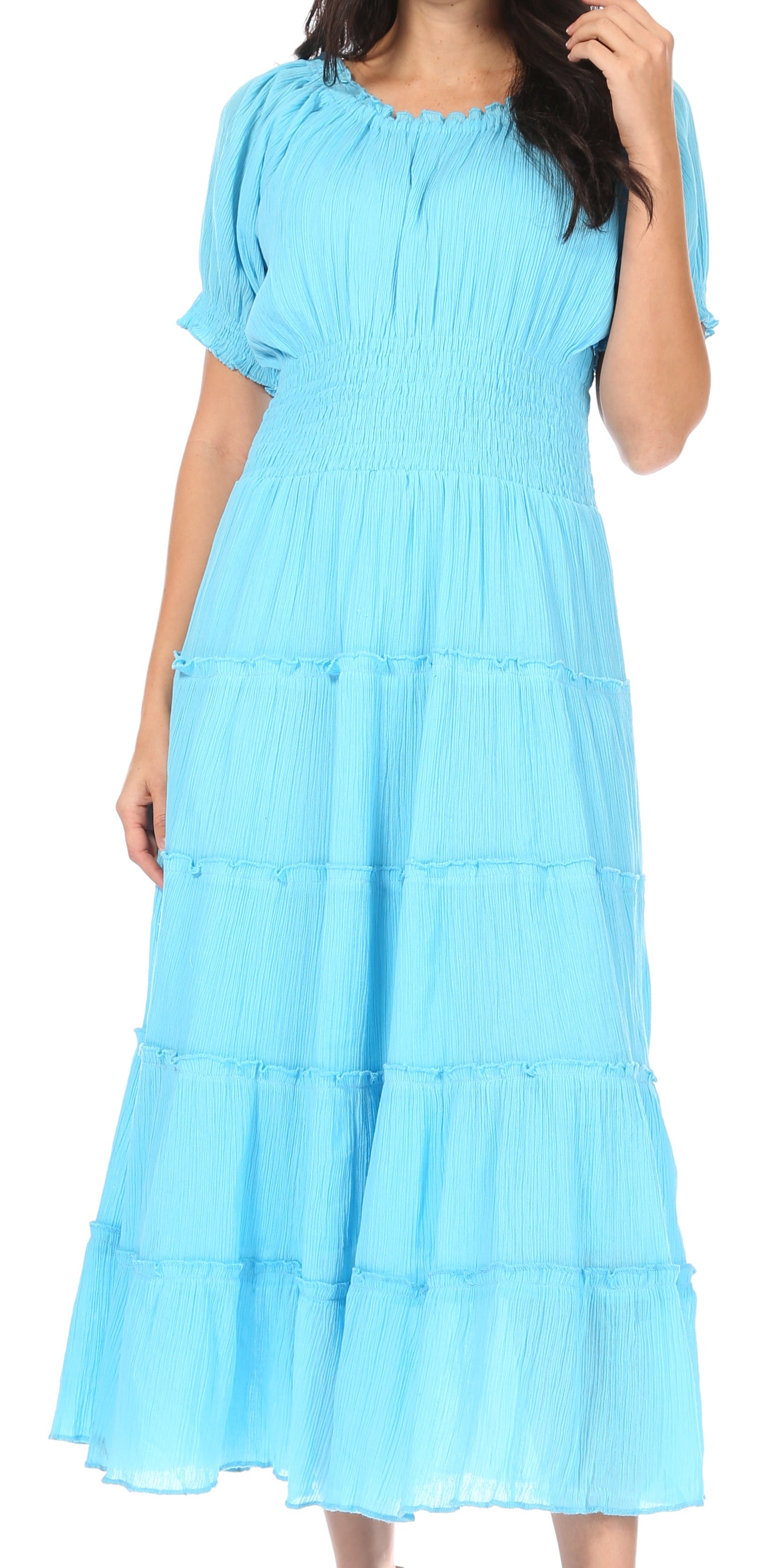 Woman wearing a light blue dress with ruffled layers.