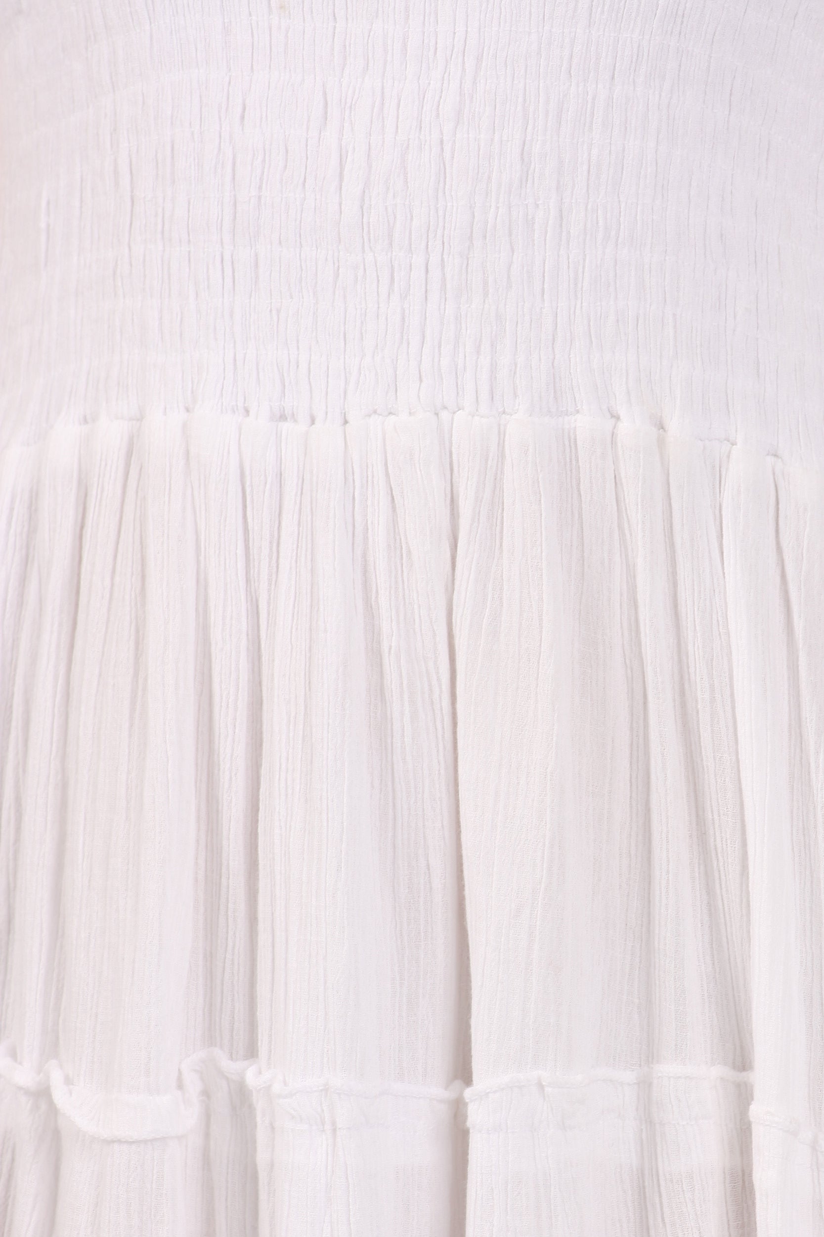 Close-up of a textured white fabric with pleated details