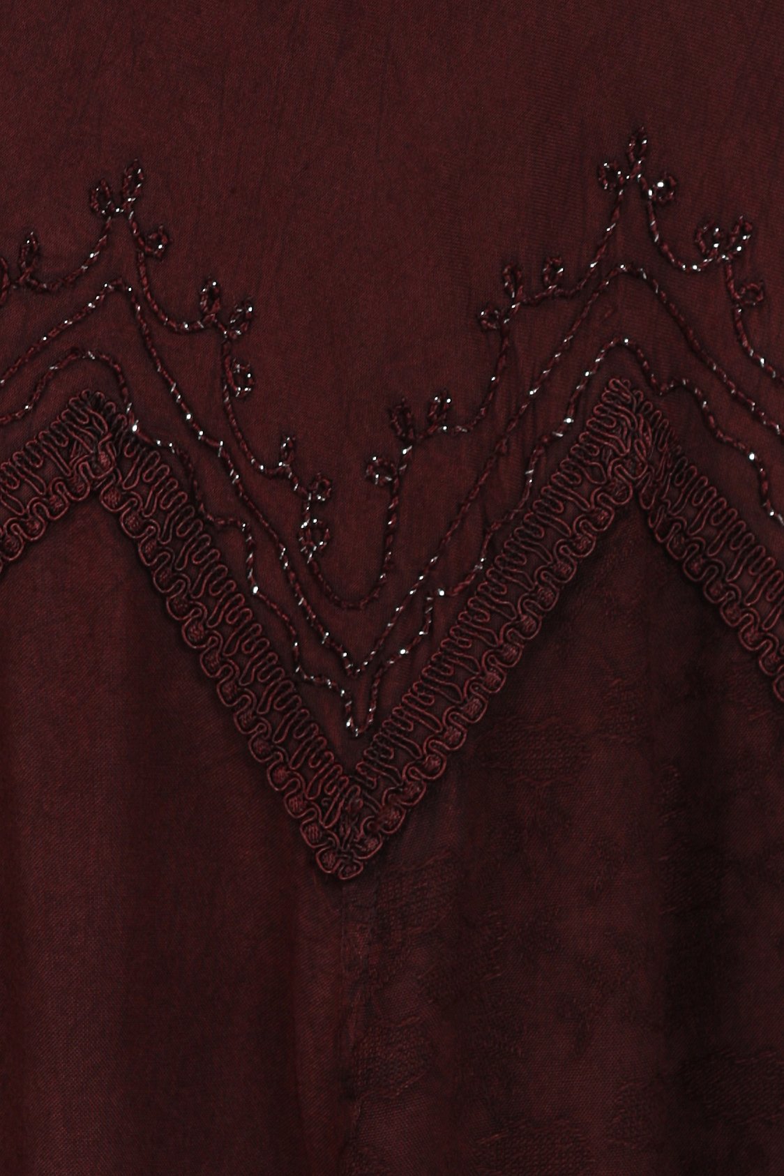 Close-up of a burgundy fabric with intricate beaded detailing