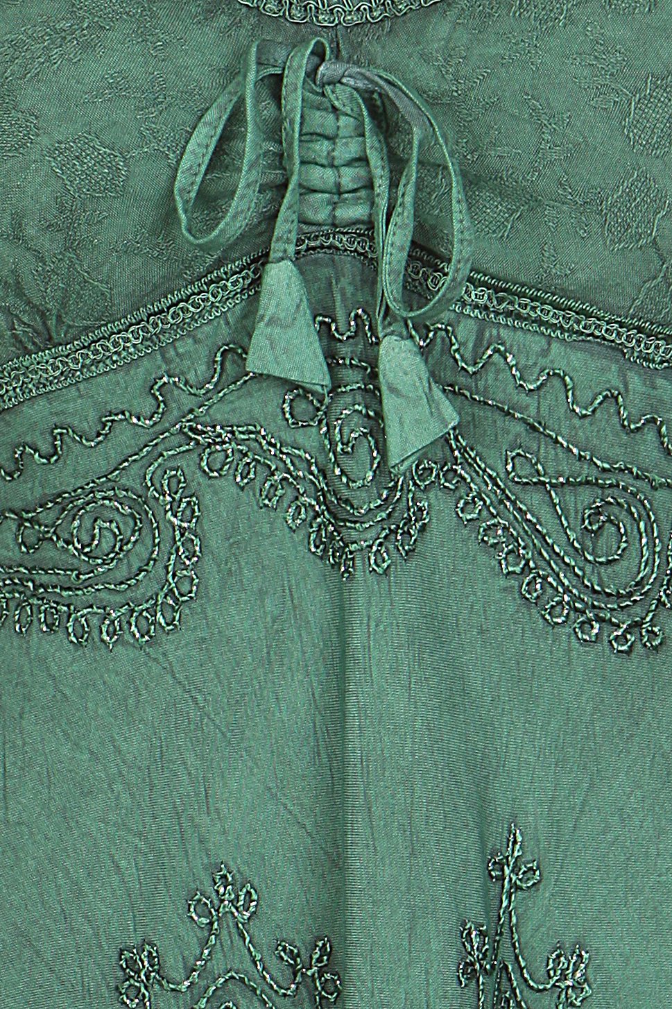 Close-up of a green embroidered garment with intricate patterns.