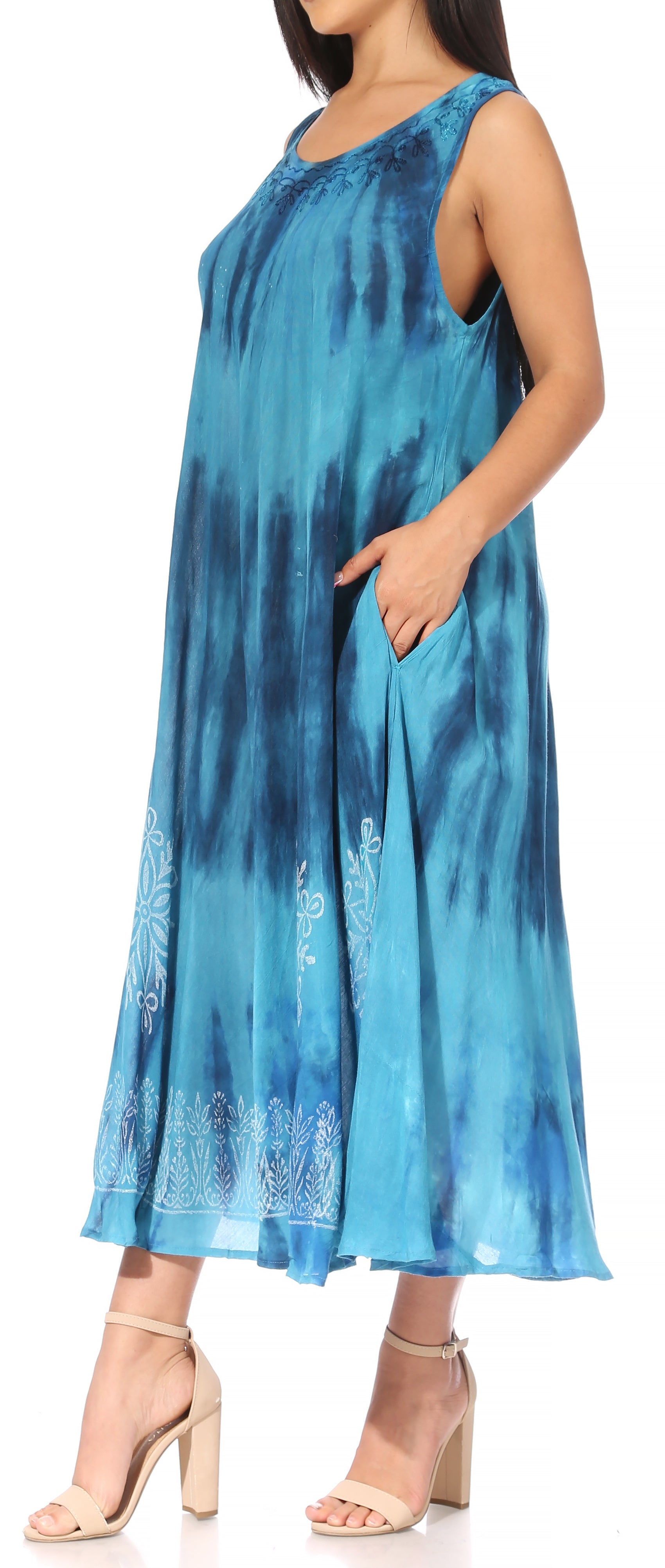 Woman wearing a blue tie-dye dress with a white background