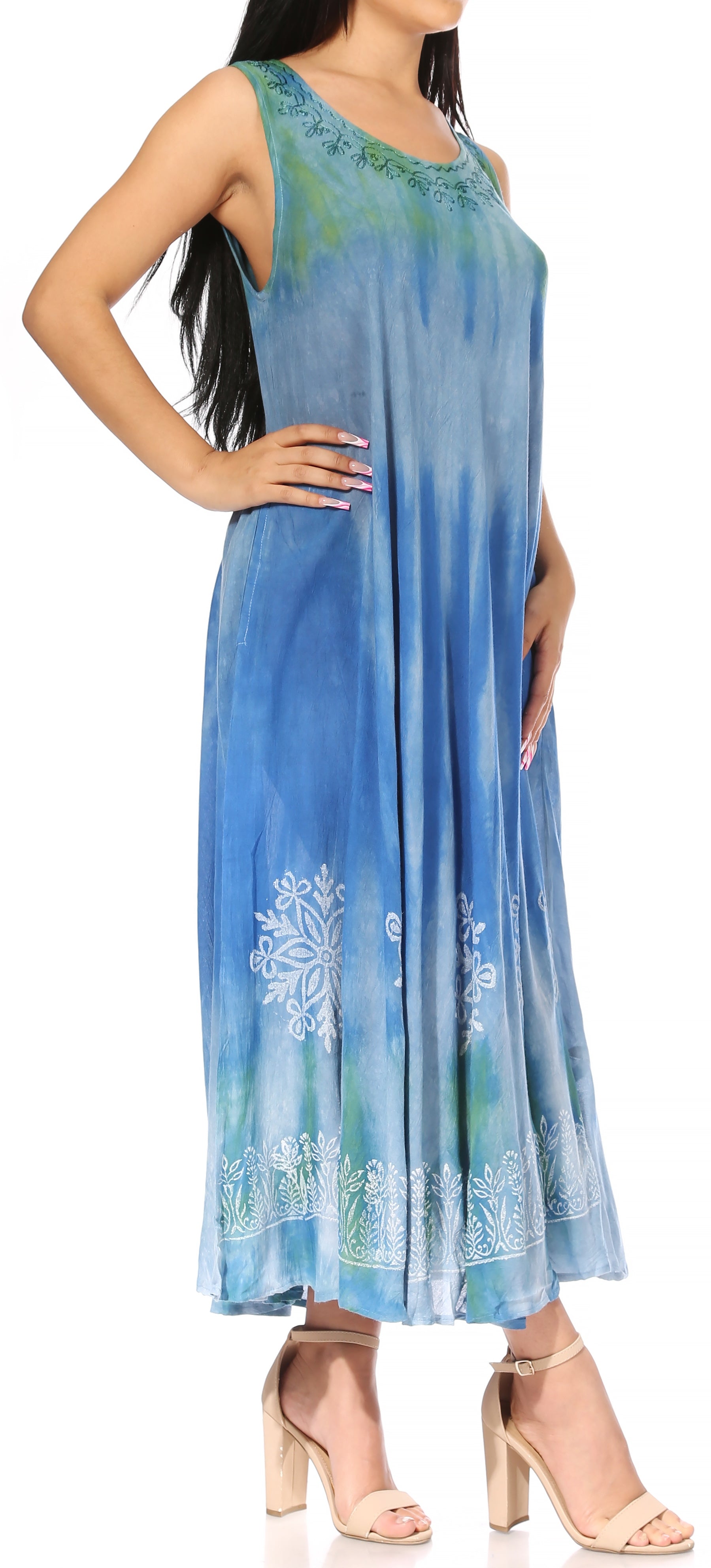 Woman wearing a blue sleeveless dress with floral patterns on a white background