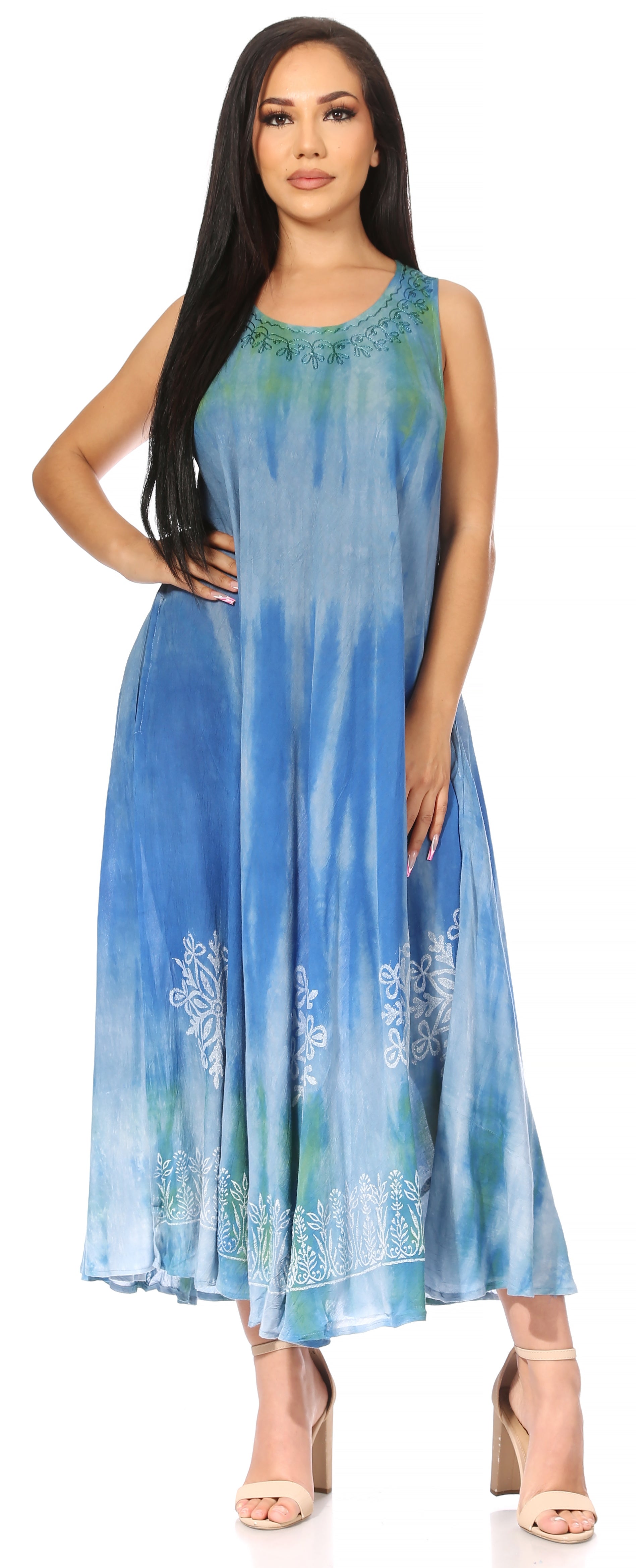 Woman wearing a blue tie-dye dress with floral patterns on a white background
