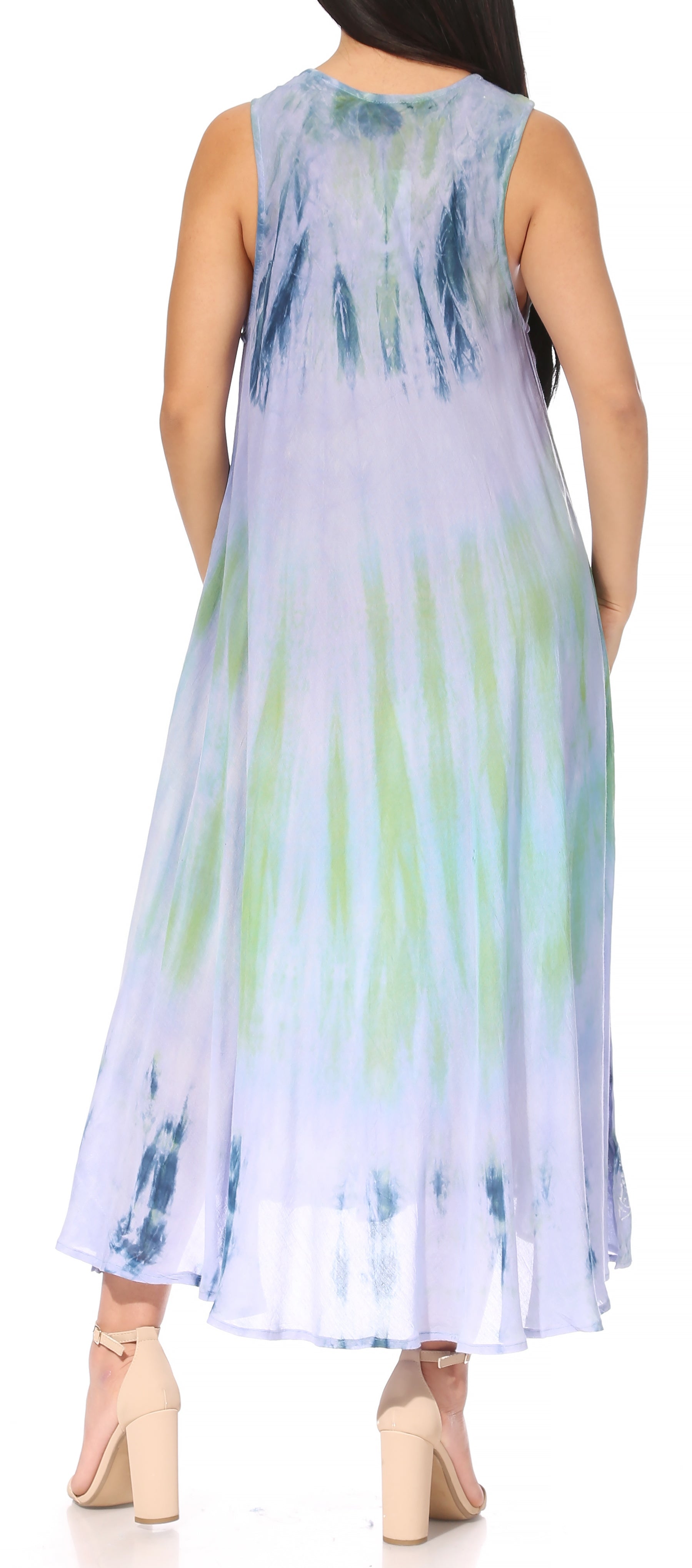 Woman wearing a sleeveless dress with a tie-dye pattern in blue, green, and white.