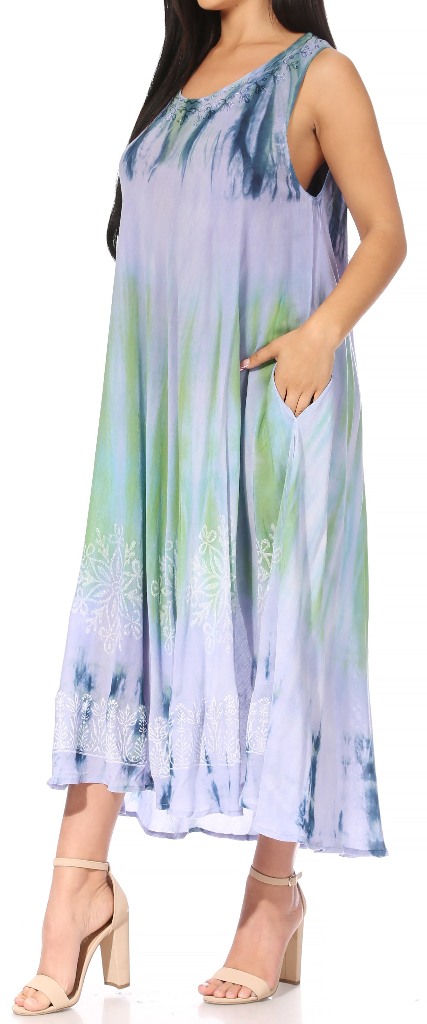 Woman wearing a tie-dye dress with a gradient of blue, green, and purple.