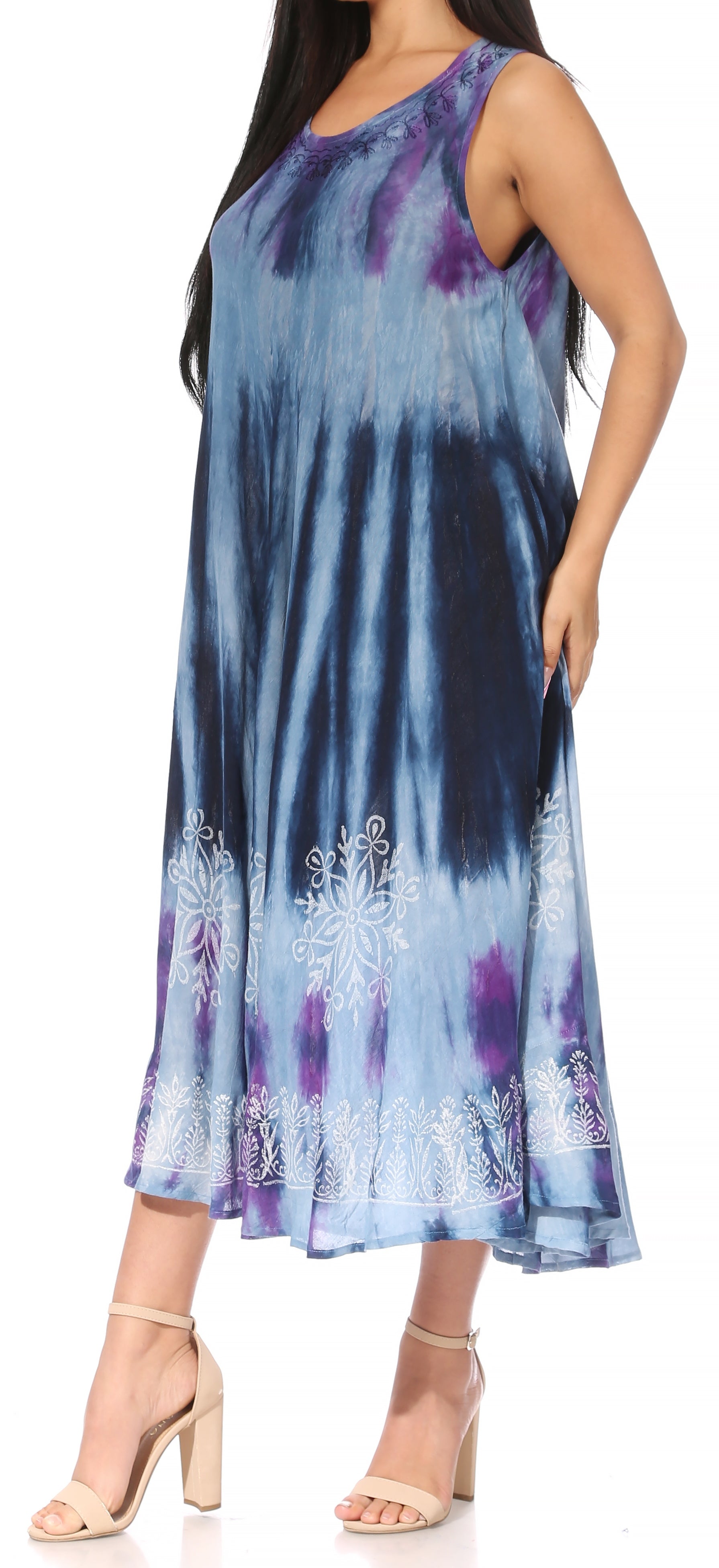 Woman wearing a tie-dye dress with floral patterns on a white background