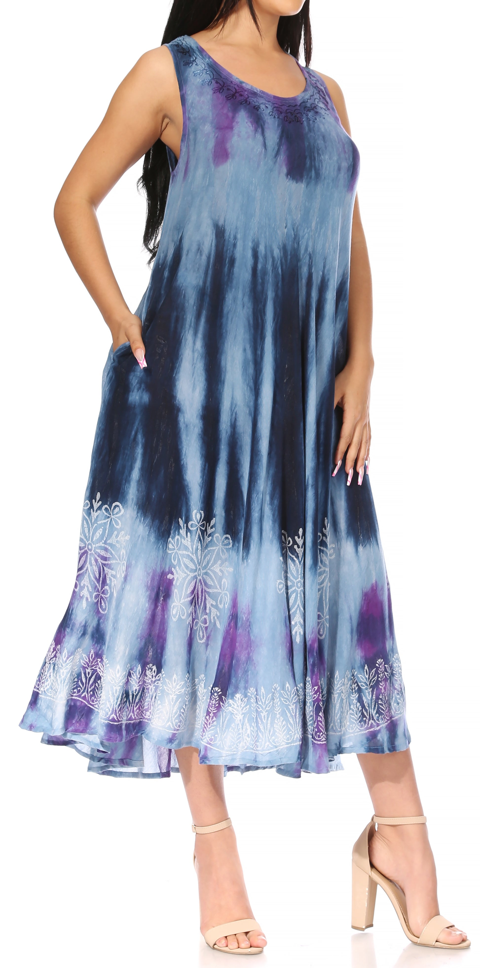 Woman wearing a sleeveless dress with blue and purple tie-dye pattern on a white background