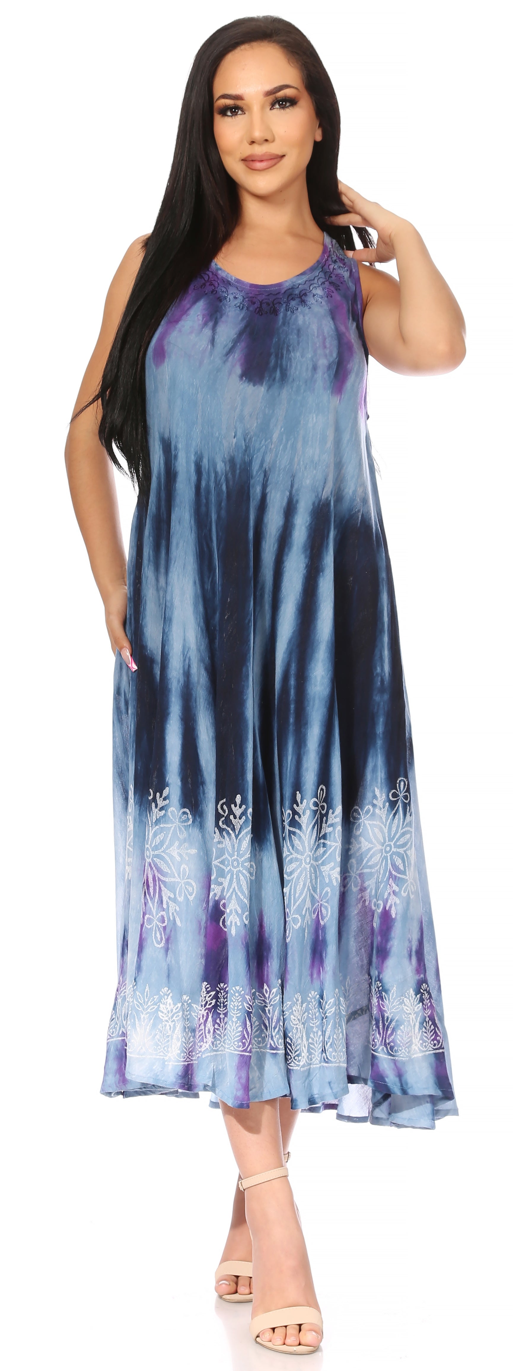 Woman wearing a blue and purple tie-dye dress with floral patterns on a white background