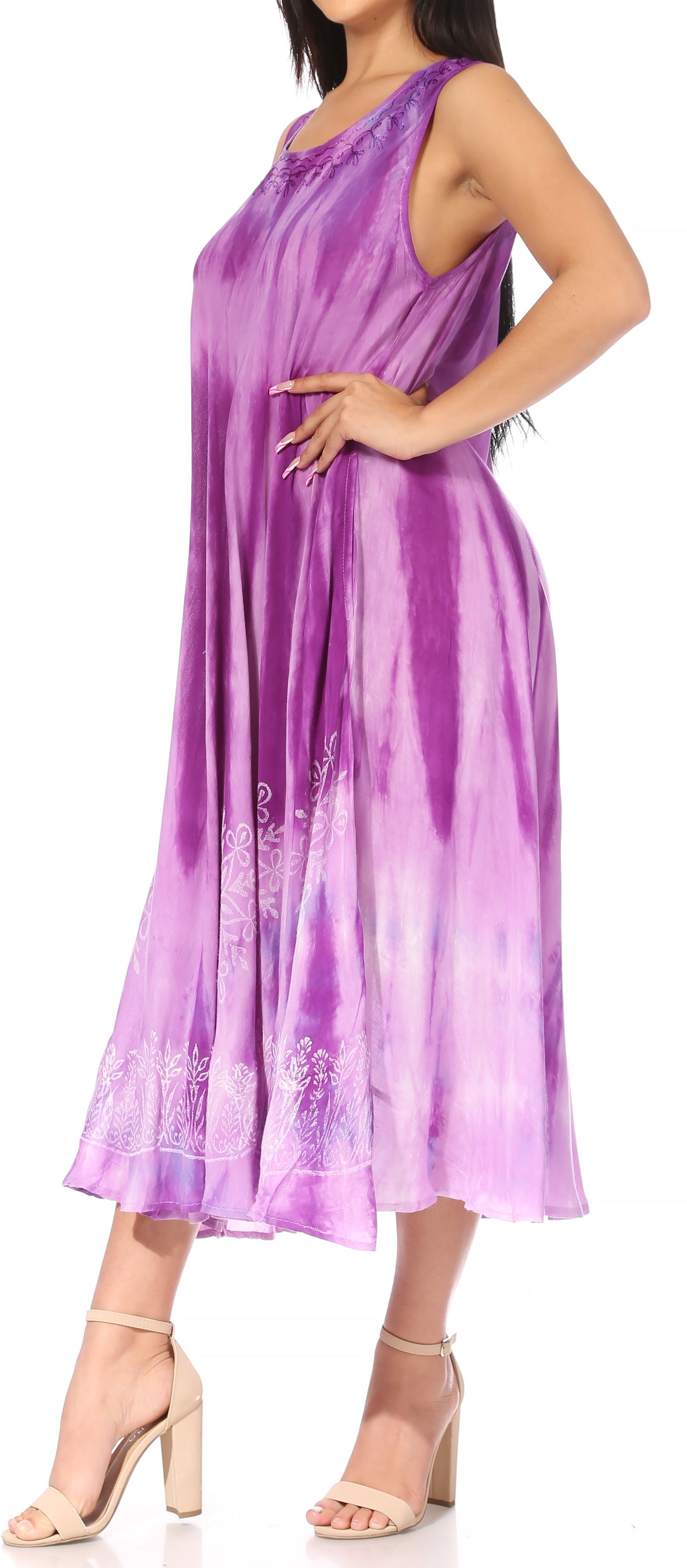 Woman wearing a purple tie-dye dress with floral embroidery.