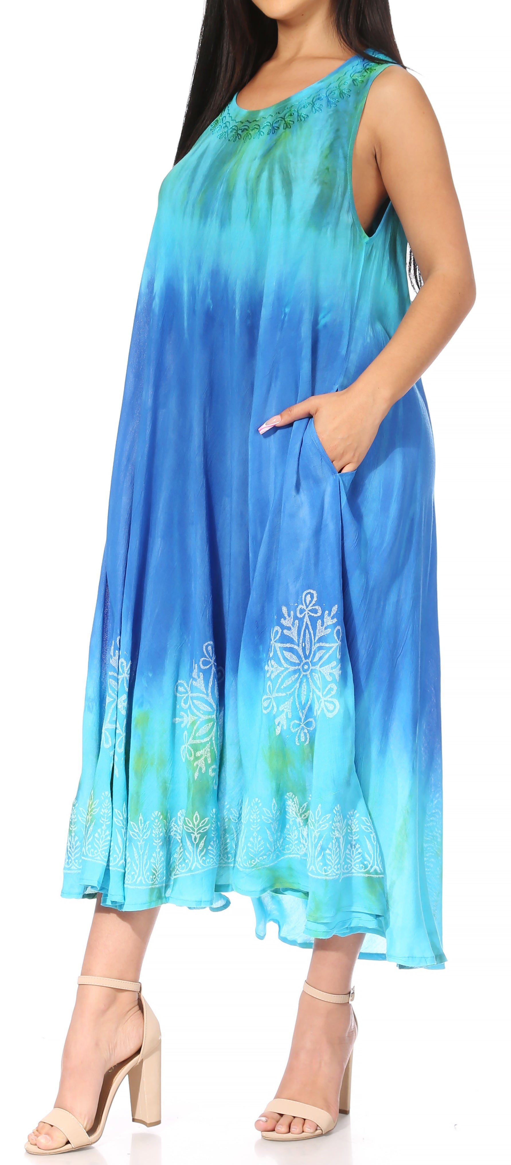 Woman wearing a blue gradient dress with floral patterns on a white background