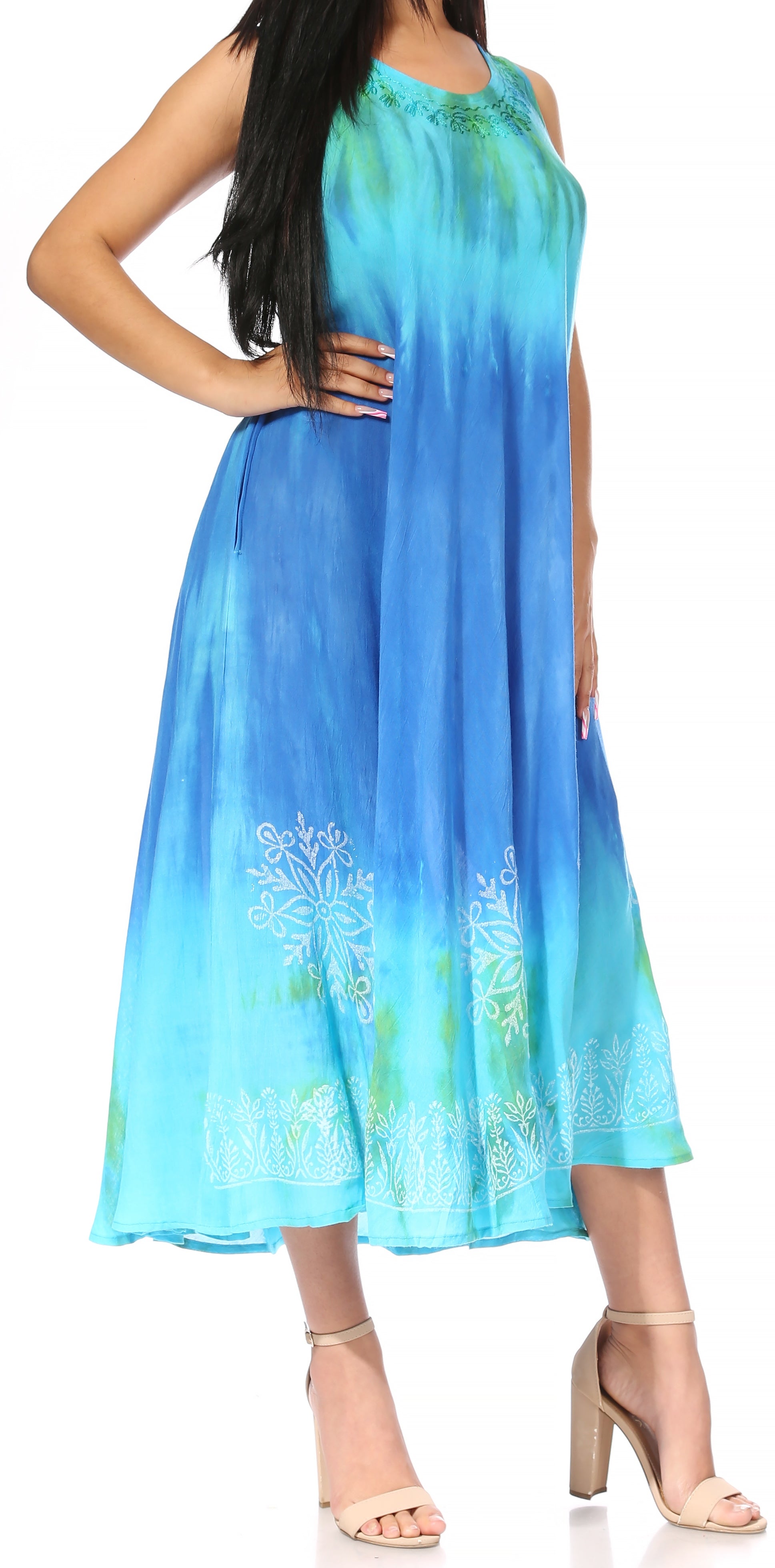 Woman wearing a blue and green gradient dress with floral patterns on a white background