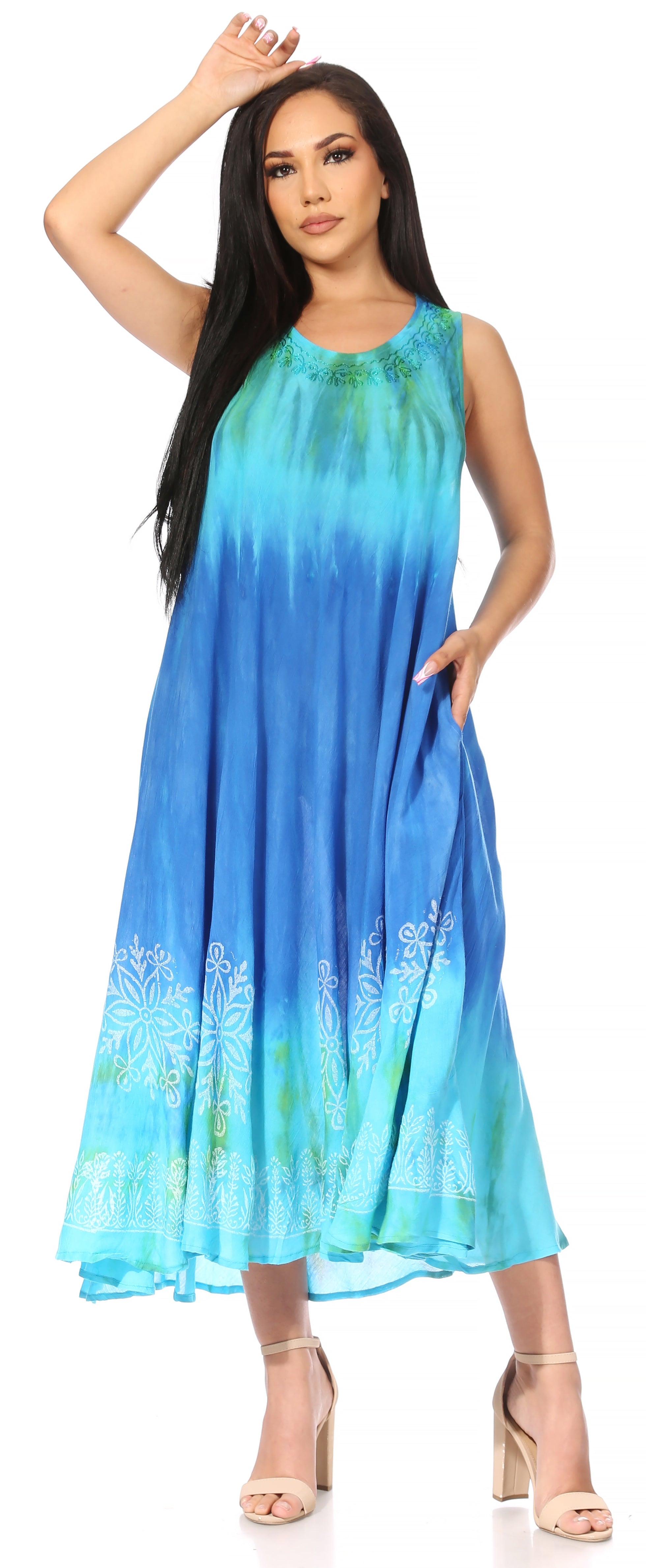 Woman wearing a blue and green gradient dress with floral patterns on a white background