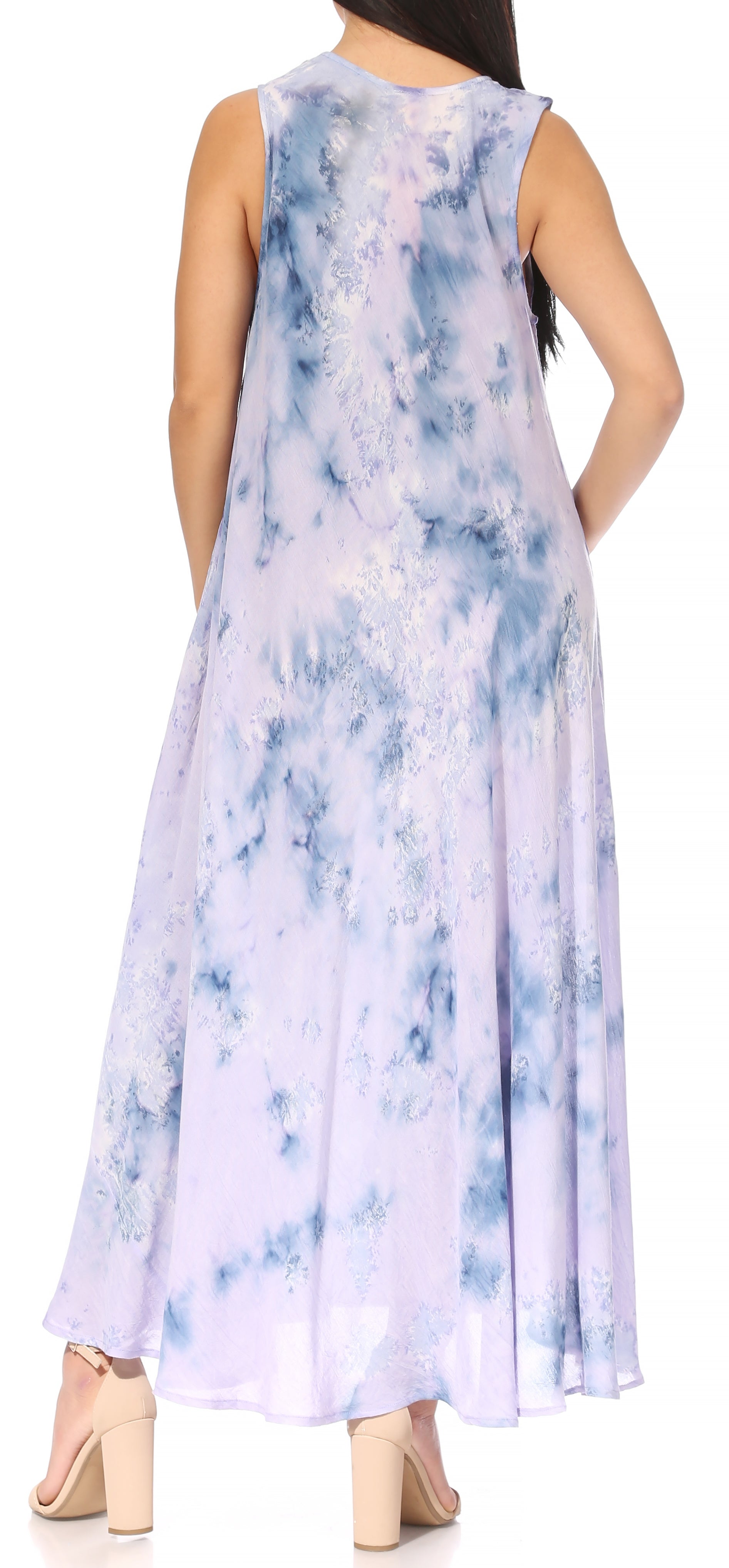 Woman wearing a sleeveless, tie-dye dress with a blue and white pattern.