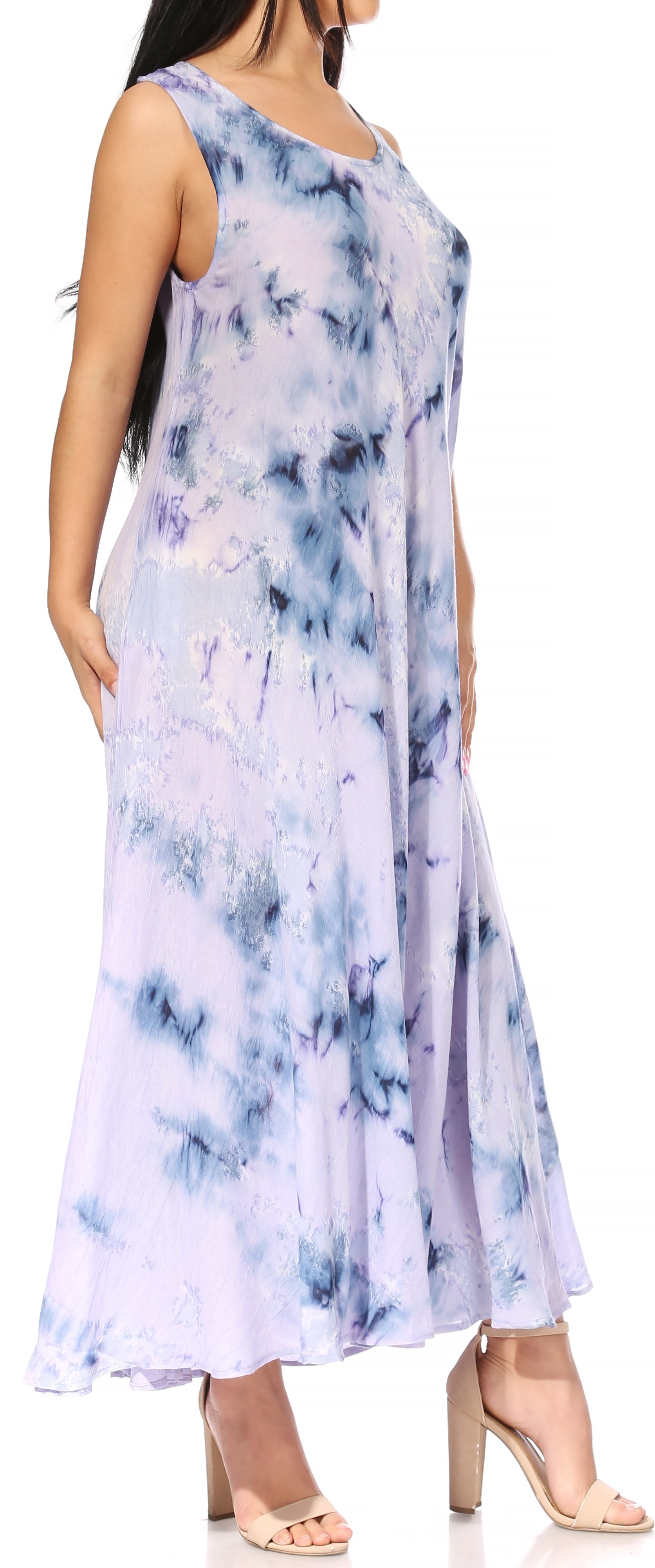 Woman wearing a tie-dye dress with blue and white patterns on a white background