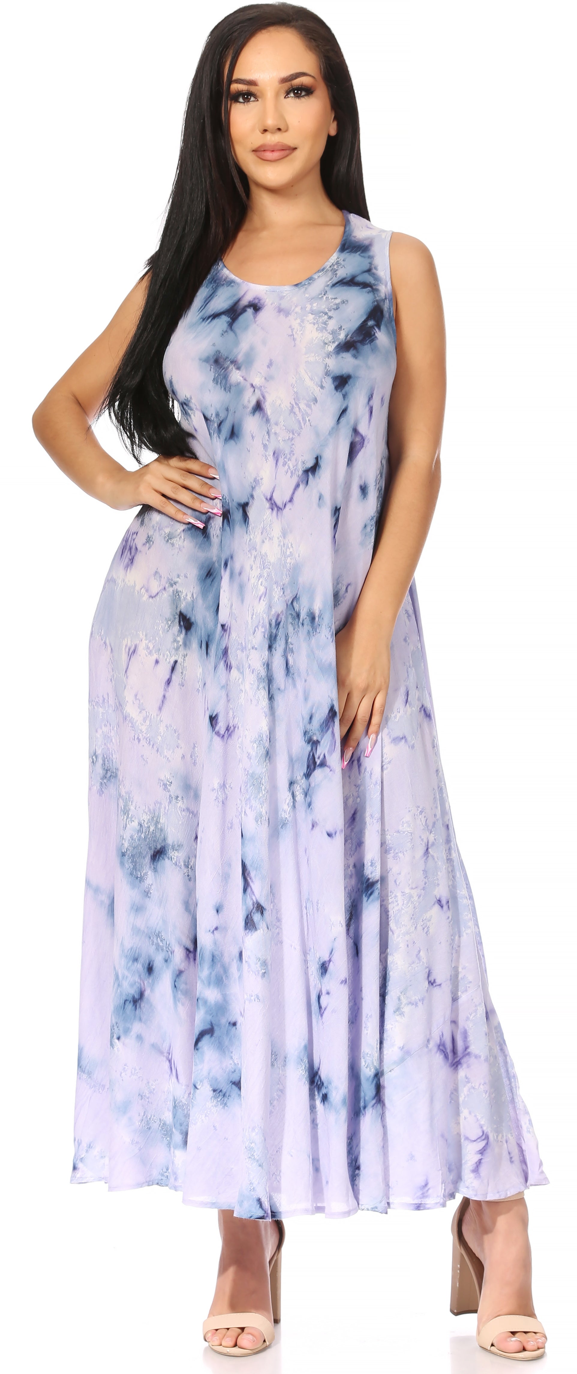 Woman wearing a sleeveless, tie-dye dress with a white background