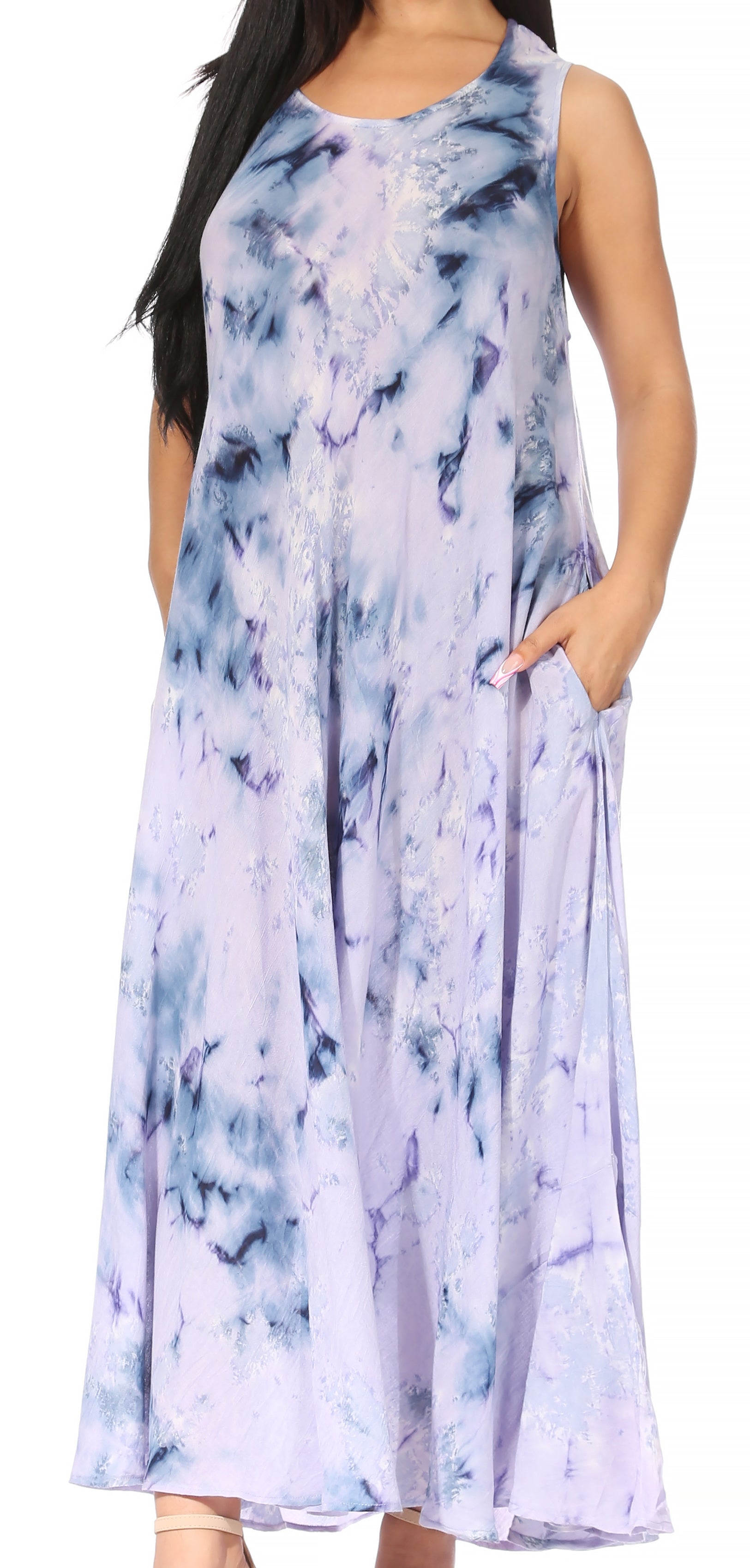 Woman wearing a sleeveless dress with a blue and white tie-dye pattern on a white background