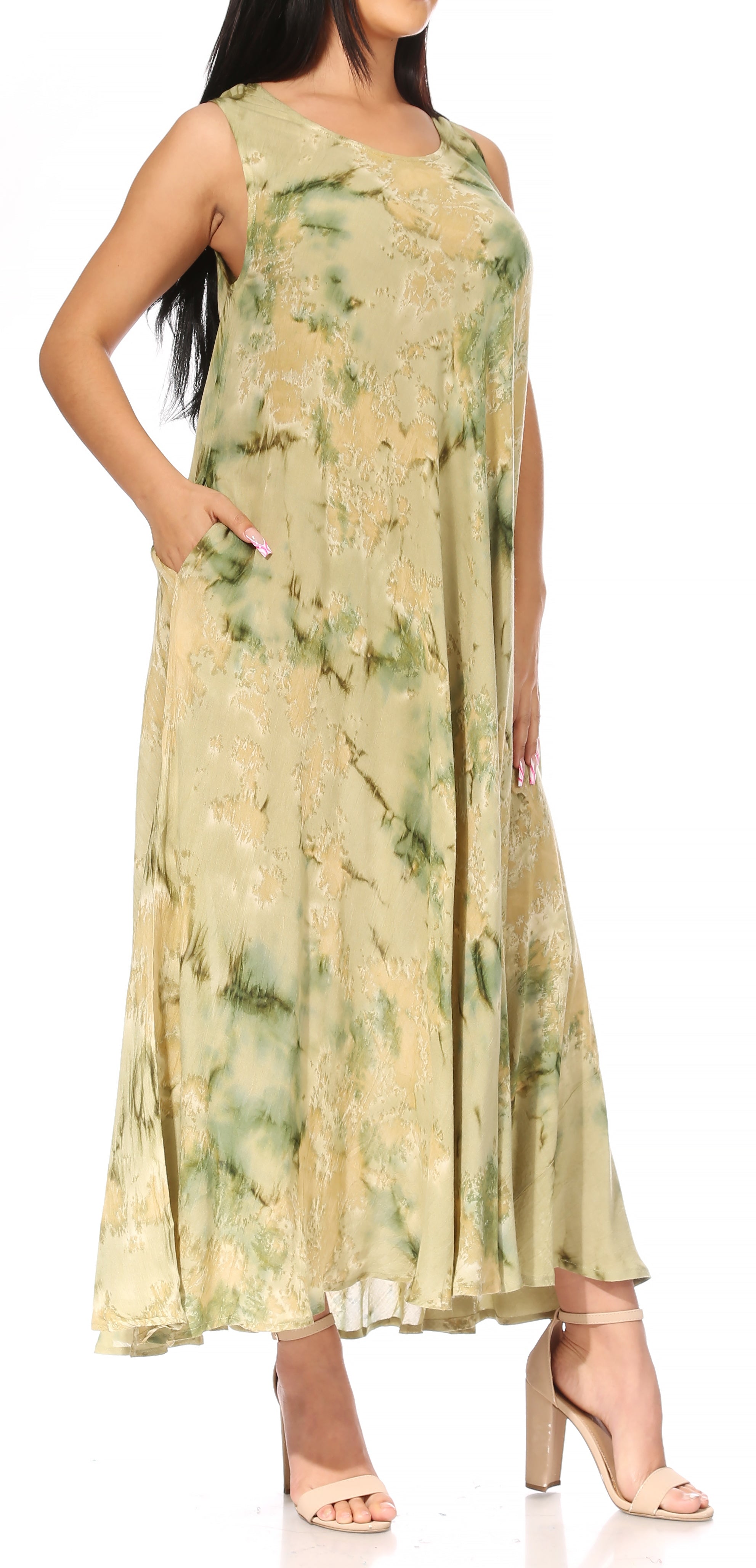 Woman wearing a long, light green floral dress on a white background